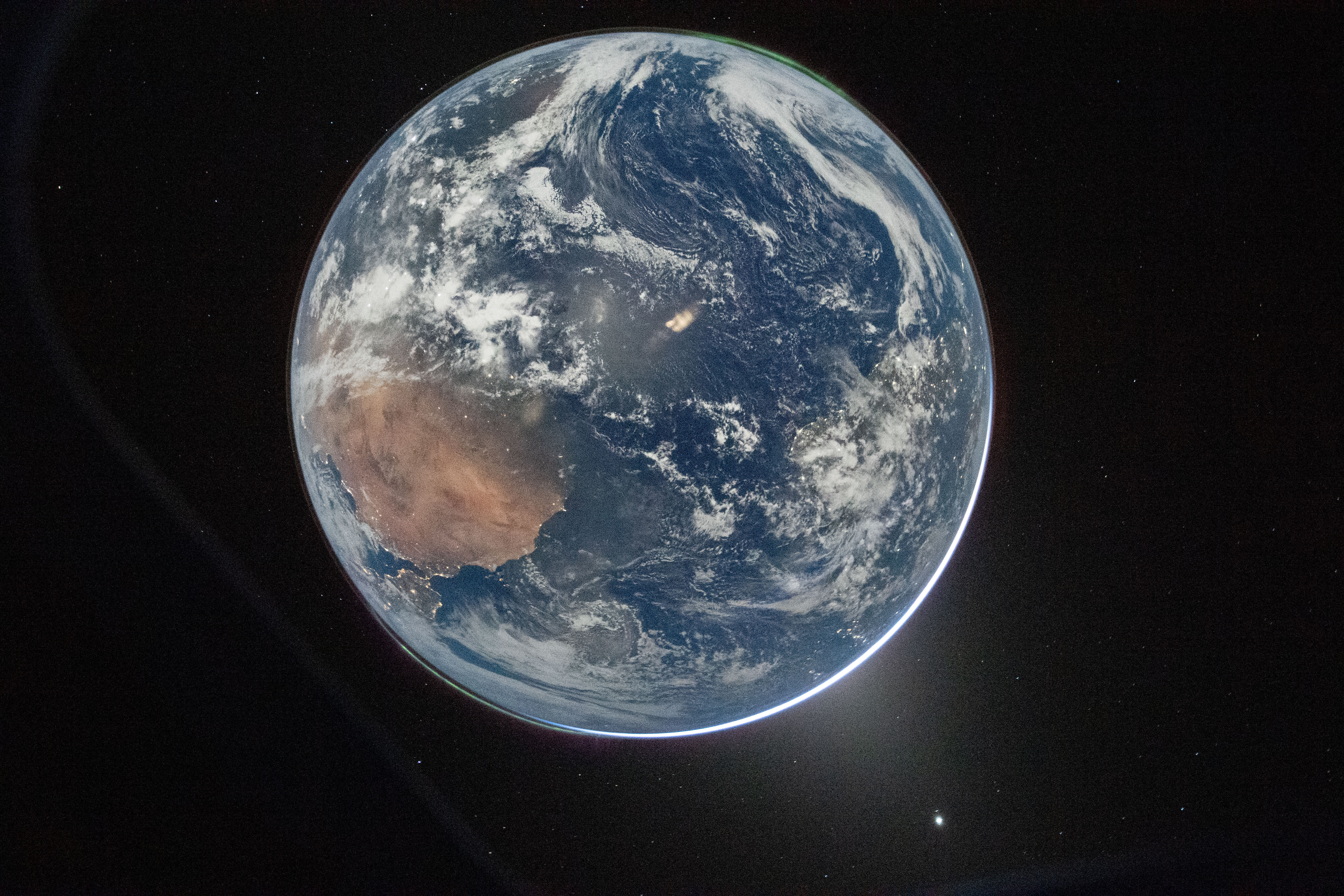 This image provided by NASA shows a view of Earth taken by NASA astronaut and Artemis II Commander Reid Wiseman from the Orion spacecraft's window after completing the translunar injection burn on April 2, 2026. [NASA/AP]