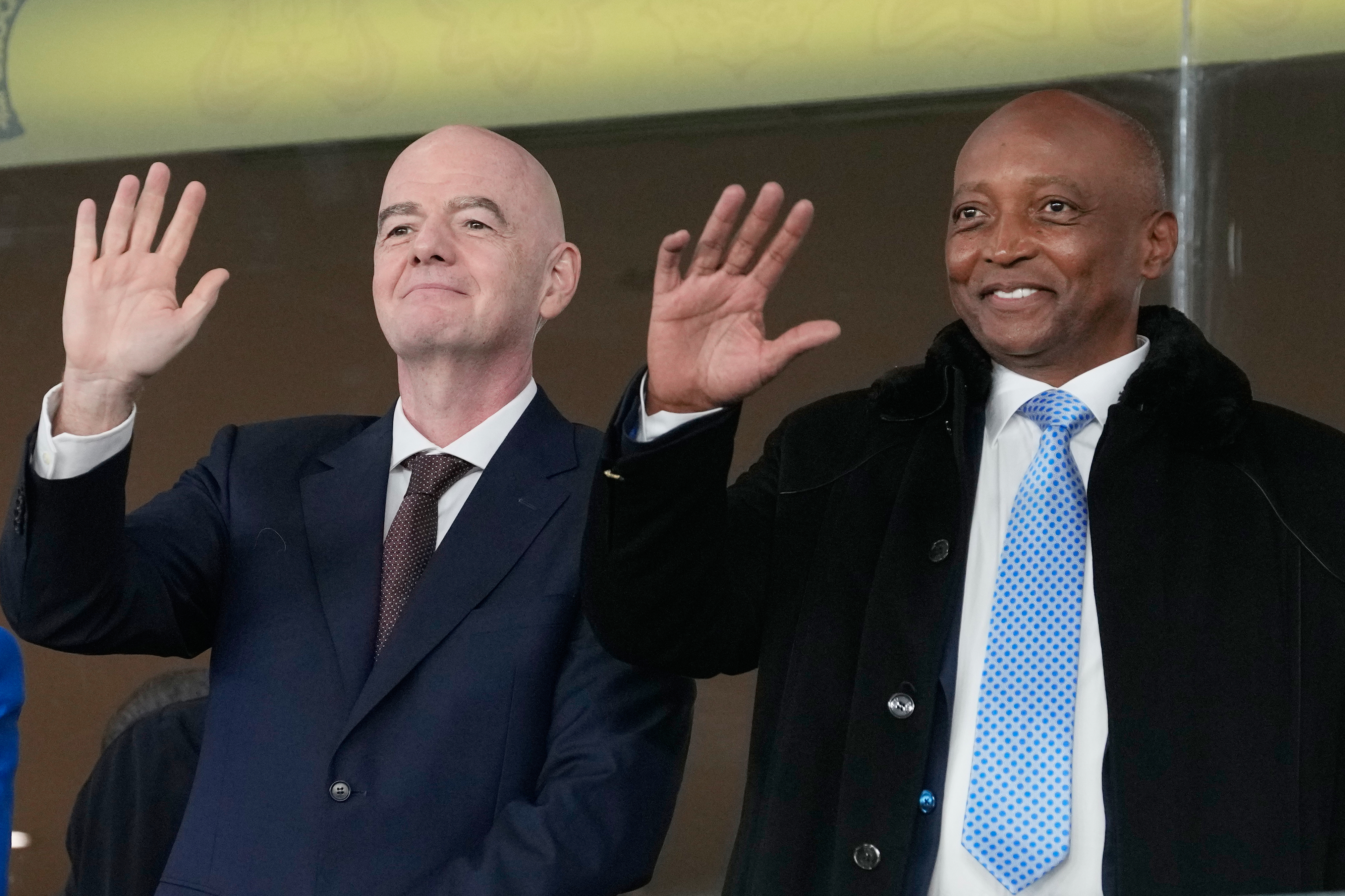 CAF President Patrice Motsepe and FIFA President Gianni Infantino wave from the tribune during the 2025 Africa Cup of Nations