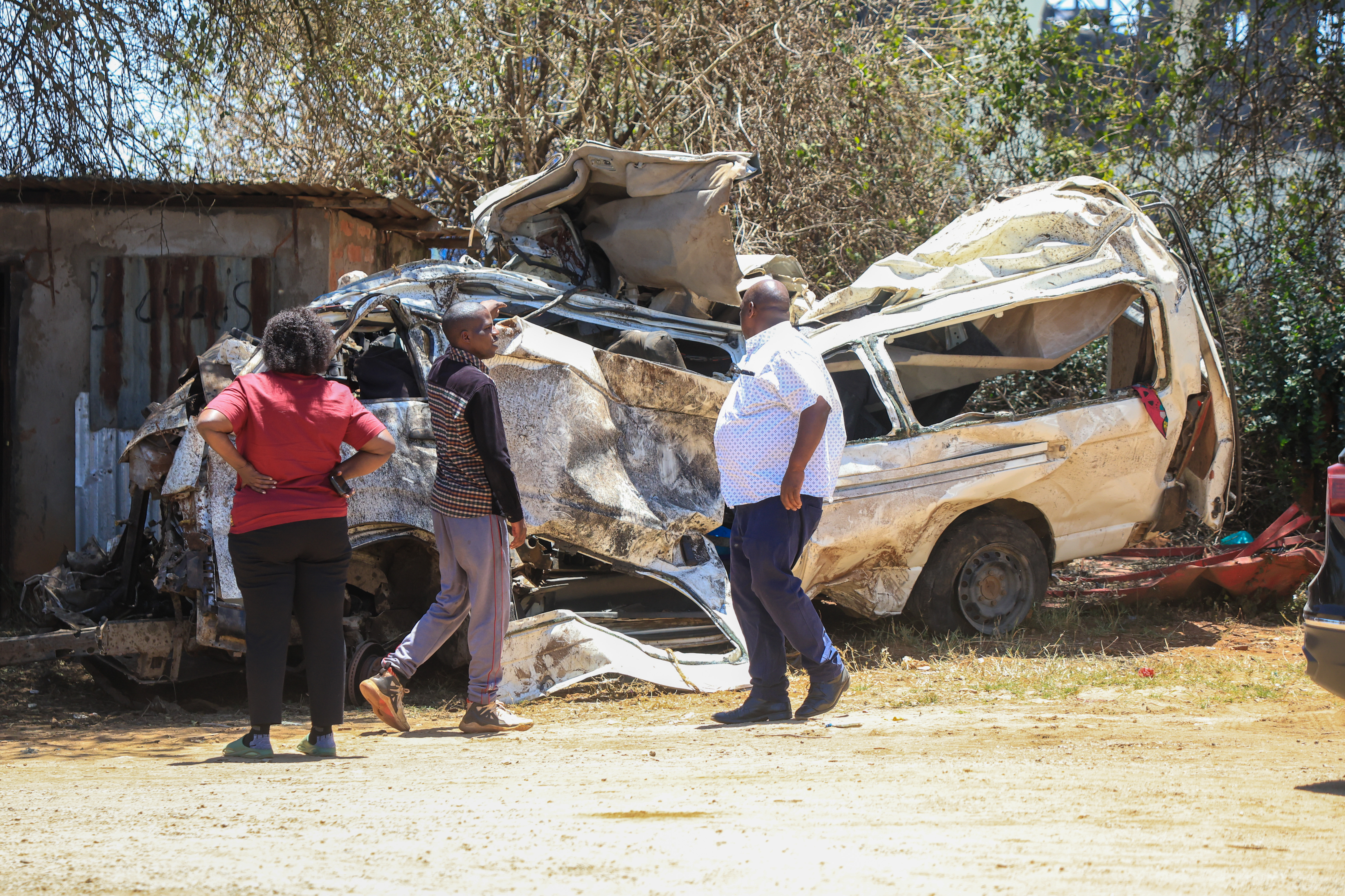 People view the wreckage of a 14-seater minibus that was involved in an accident killing all the passengers, in the Salama area in eastern Kenya, on October 3, 2026 [Andrew Kasuku/ AP Photo]