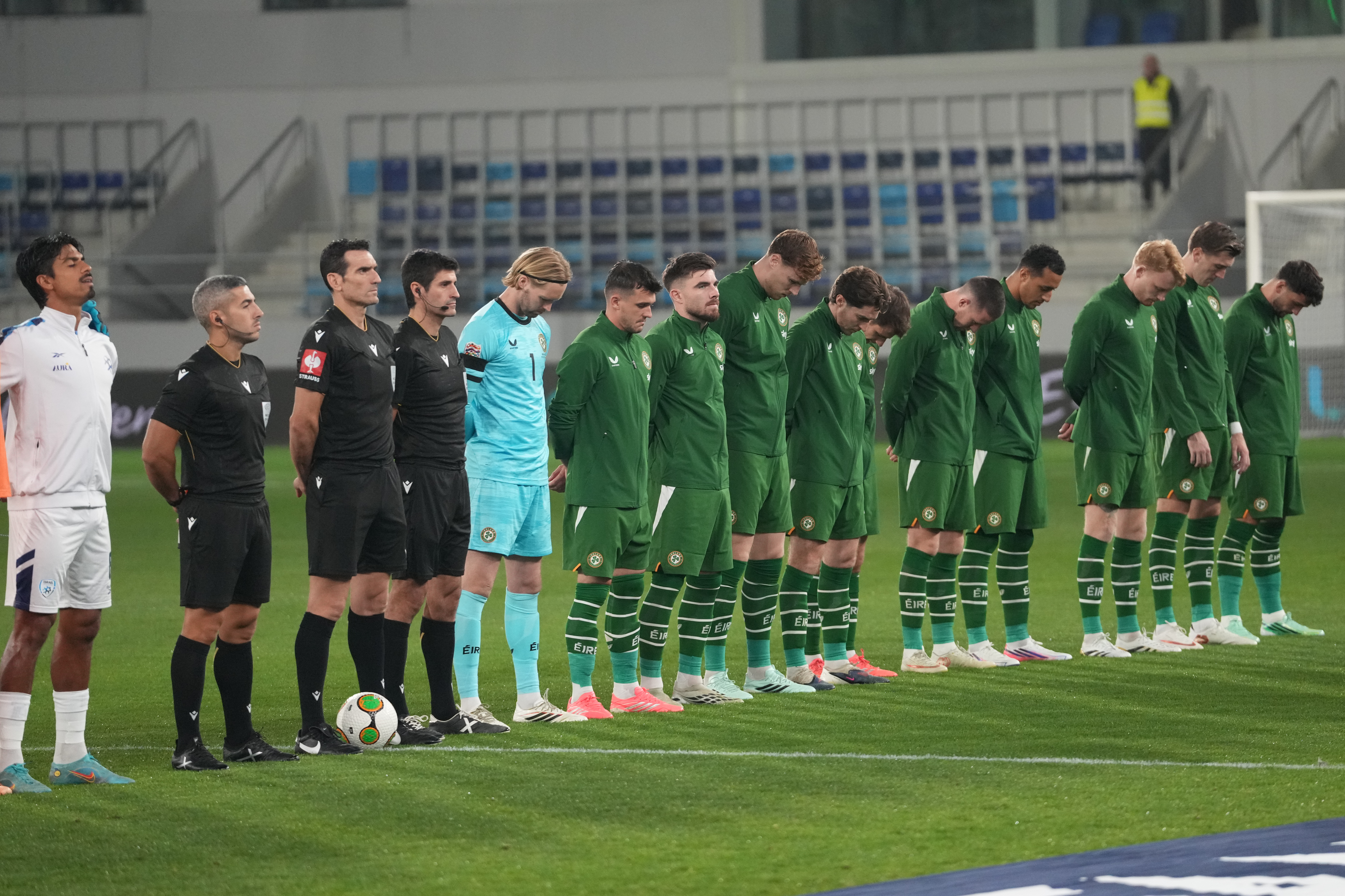 Irish players bow their heads during Israeli national anthem before the UEFA Nations League soccer match between the Republic of Ireland and Israel