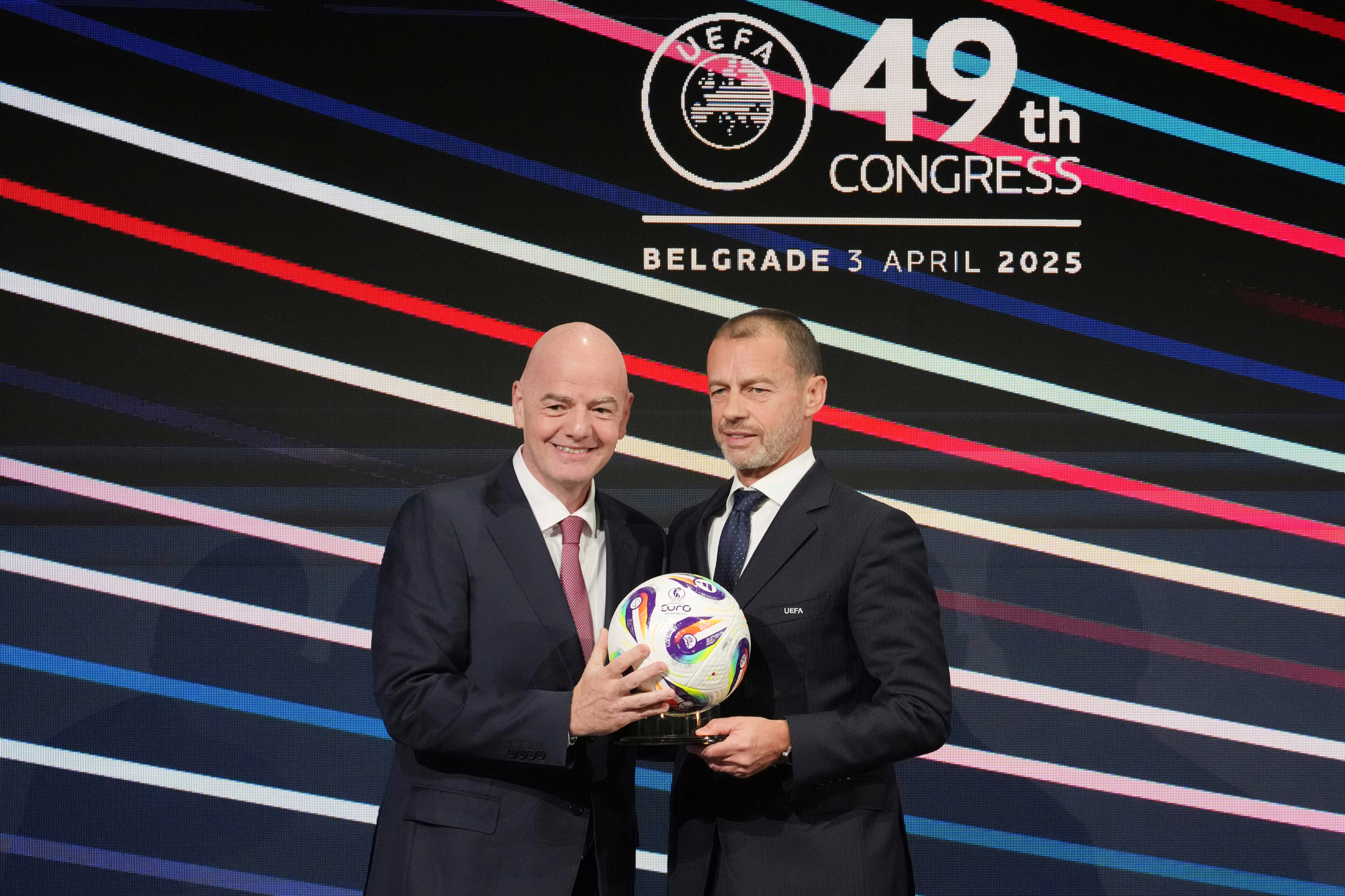 UEFA President Aleksander Ceferin, right, and FIFA president Gianni Infantino, left, holding a ball during the 49th UEFA congress in 2025