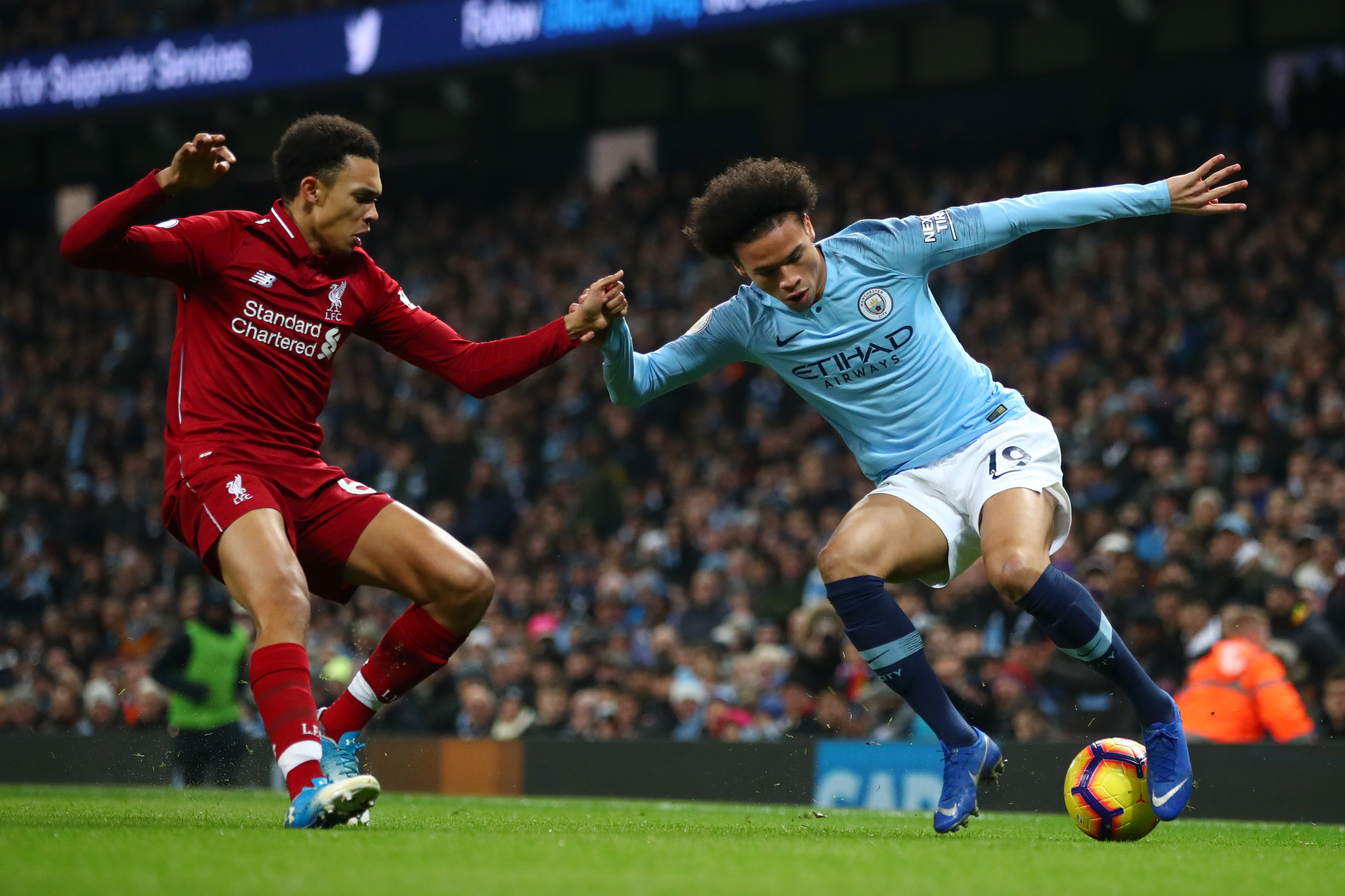 MANCHESTER, ENGLAND - JANUARY 03: Leroy Sane of Manchester City is challenged by Trent Alexander-Arnold of Liverpool during the Premier League match between Manchester City and Liverpool FC at the Etihad Stadium on January 3, 2019 in Manchester, United Kingdom. (Photo by Clive Brunskill/Getty Images)