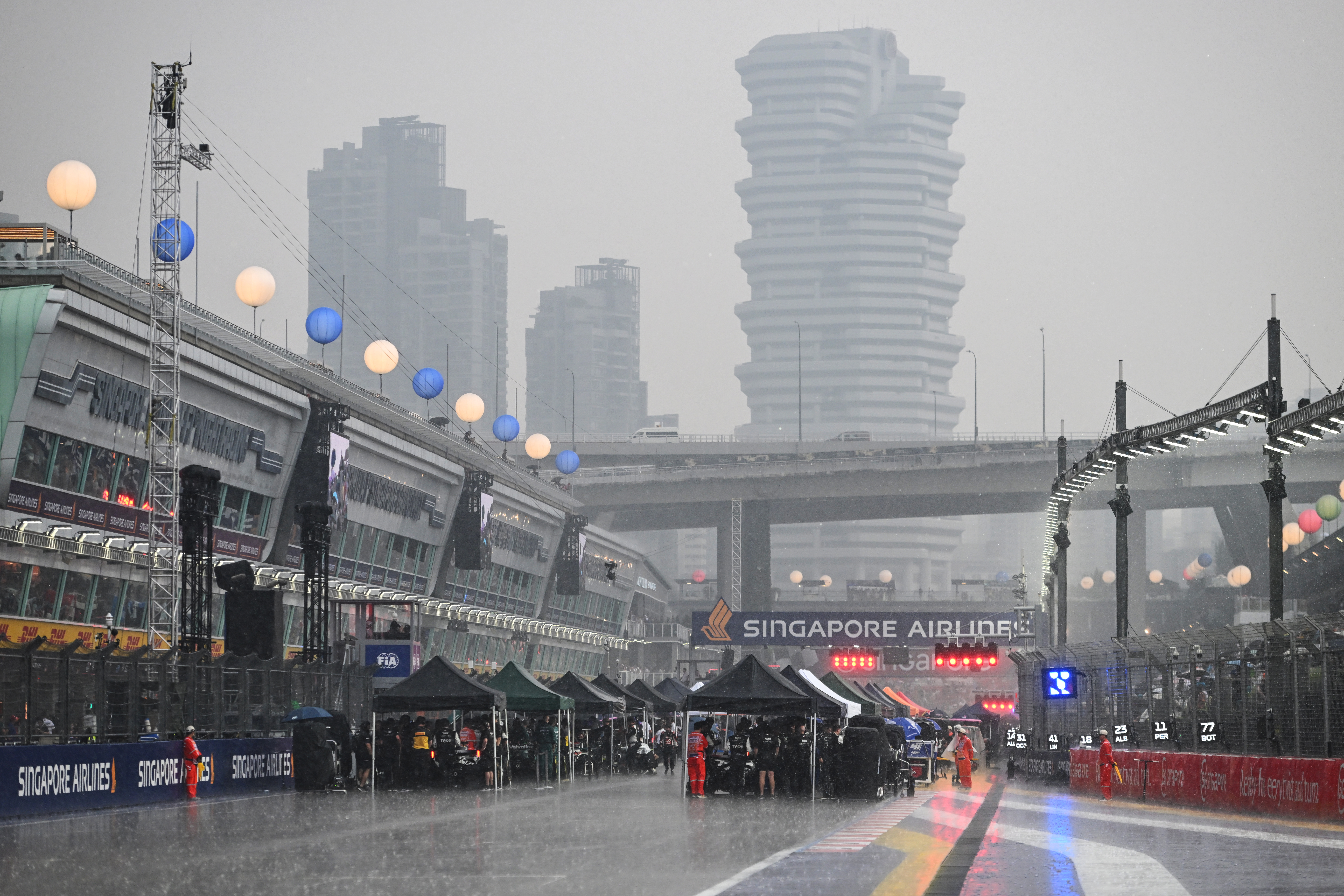 SINGAPORE, SINGAPORE - OCTOBER 10: Rain falls on the grid prior to the Sprint ahead of the F1 Grand Prix of Singapore at Marina Bay Street Circuit on October 10, 2026 in Singapore, Singapore. (Photo by Rudy Carezzevoli/Getty Images)