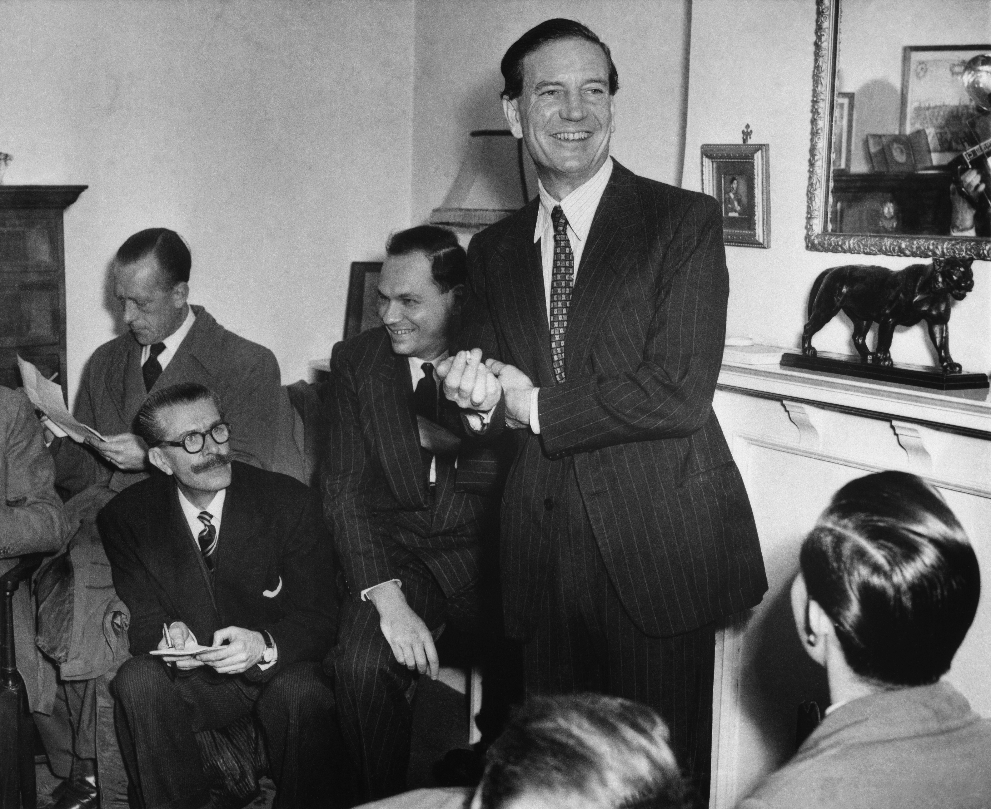 Kim Philby, British intelligence agent, jokes with newsmen at his mother's London home during a 1955 press conference where he was formally cleared of tipping off fellow agents Guy Burgess and Donald Maclean. Burgess and Maclean had defected to the Soviet Union in 1951 under the suspicion of being double agents.