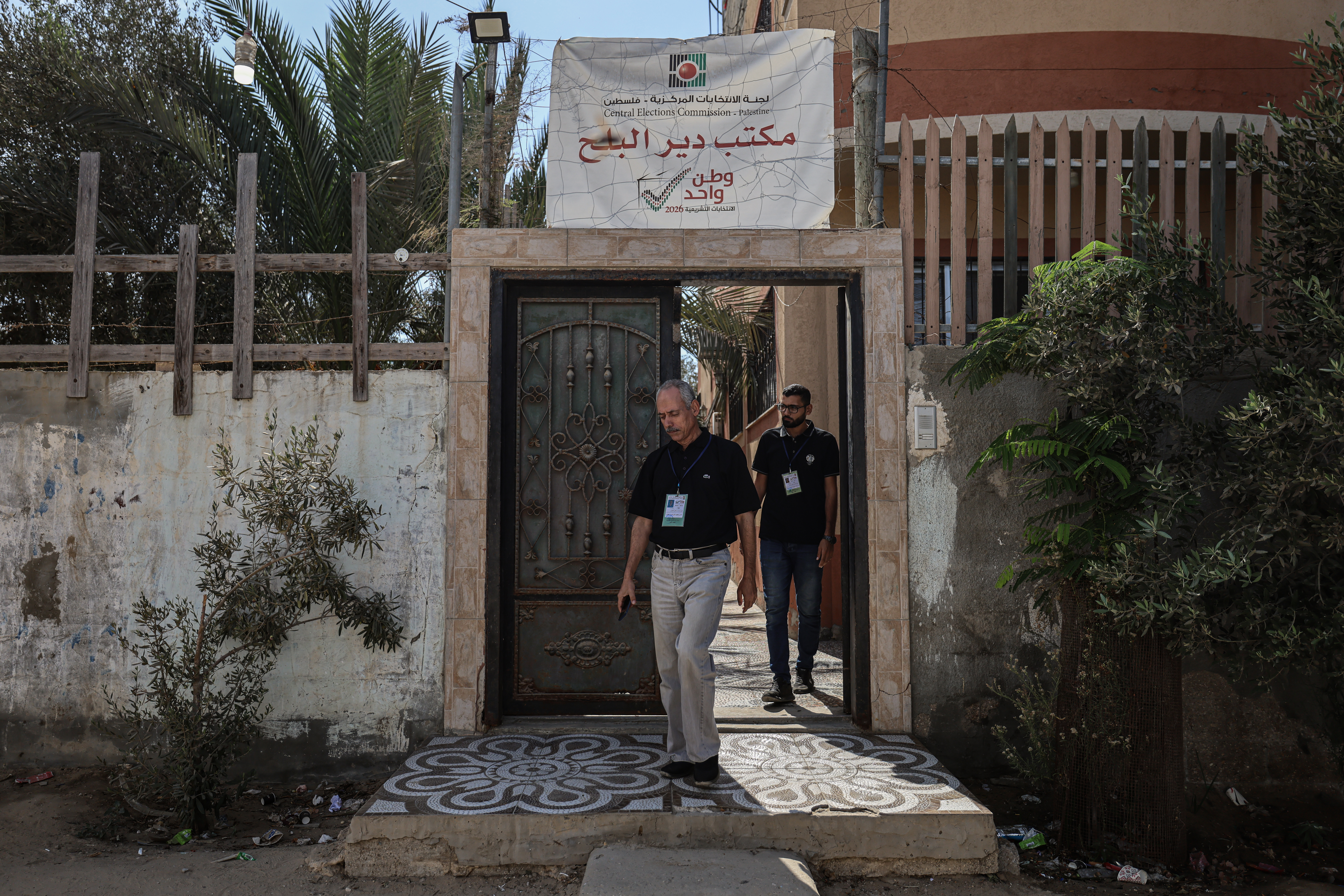 Two men outside entrance to Palestinian Election Commission office in Deir el-Balah