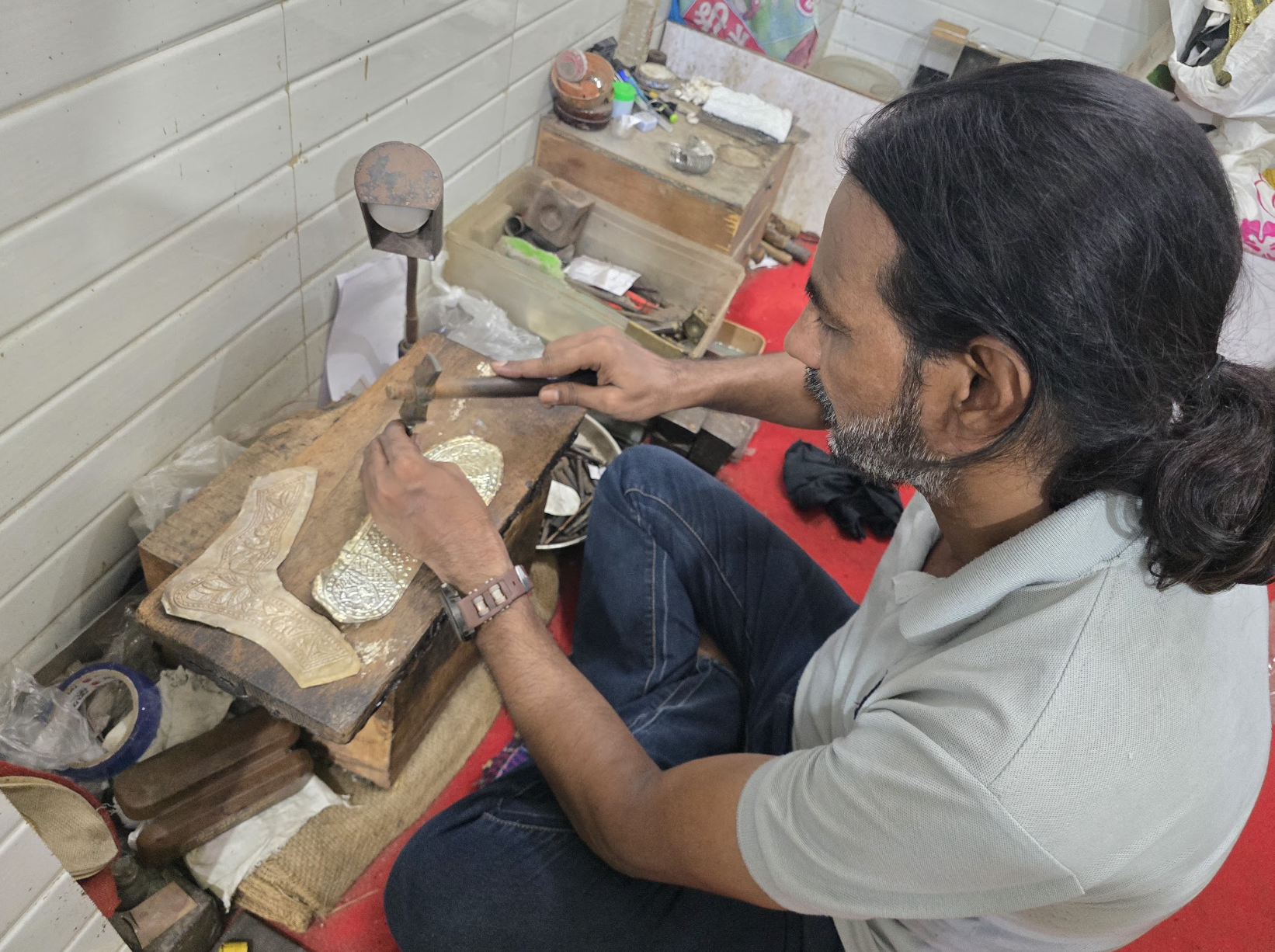 Azhar Hussain makes a nagra, a process that requires immense concentration and hours of painstaking work [Aatif Ammad/Al Jazeera]