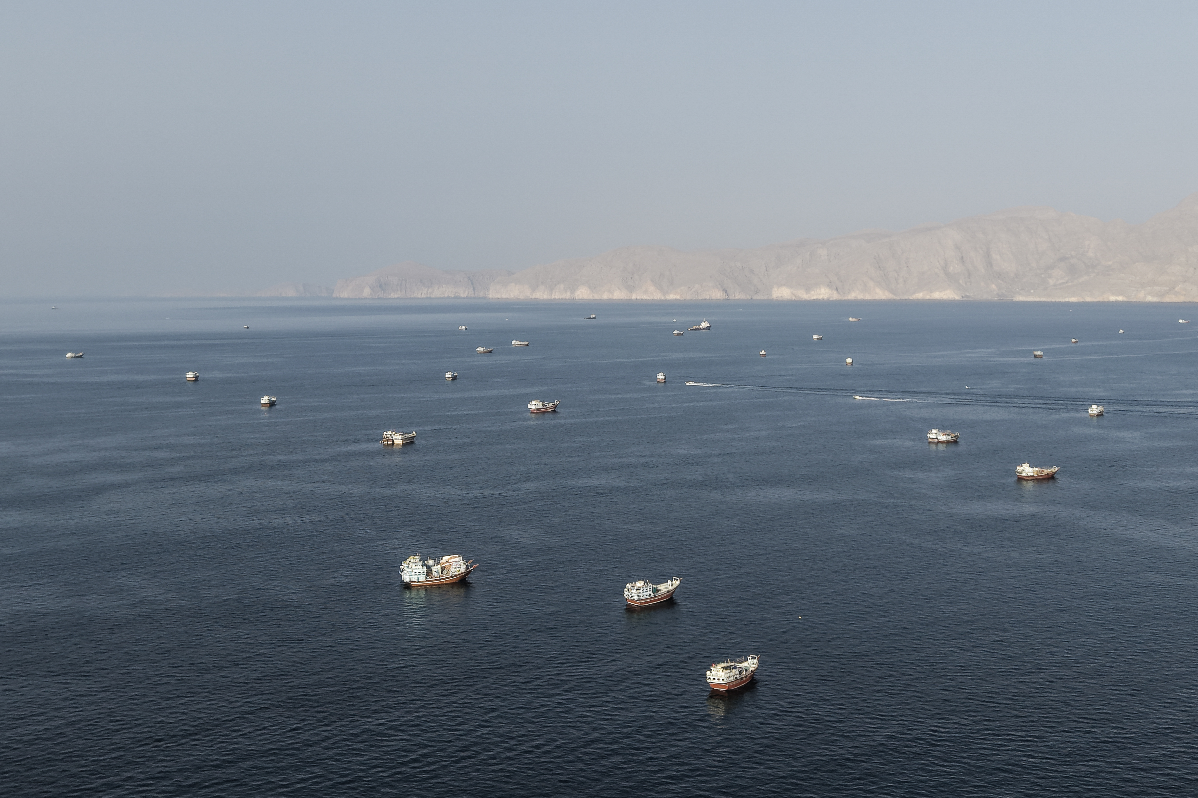 An aerial view shows ships anchored off the coast of Khasab in Oman, near the Strait of Hormuz