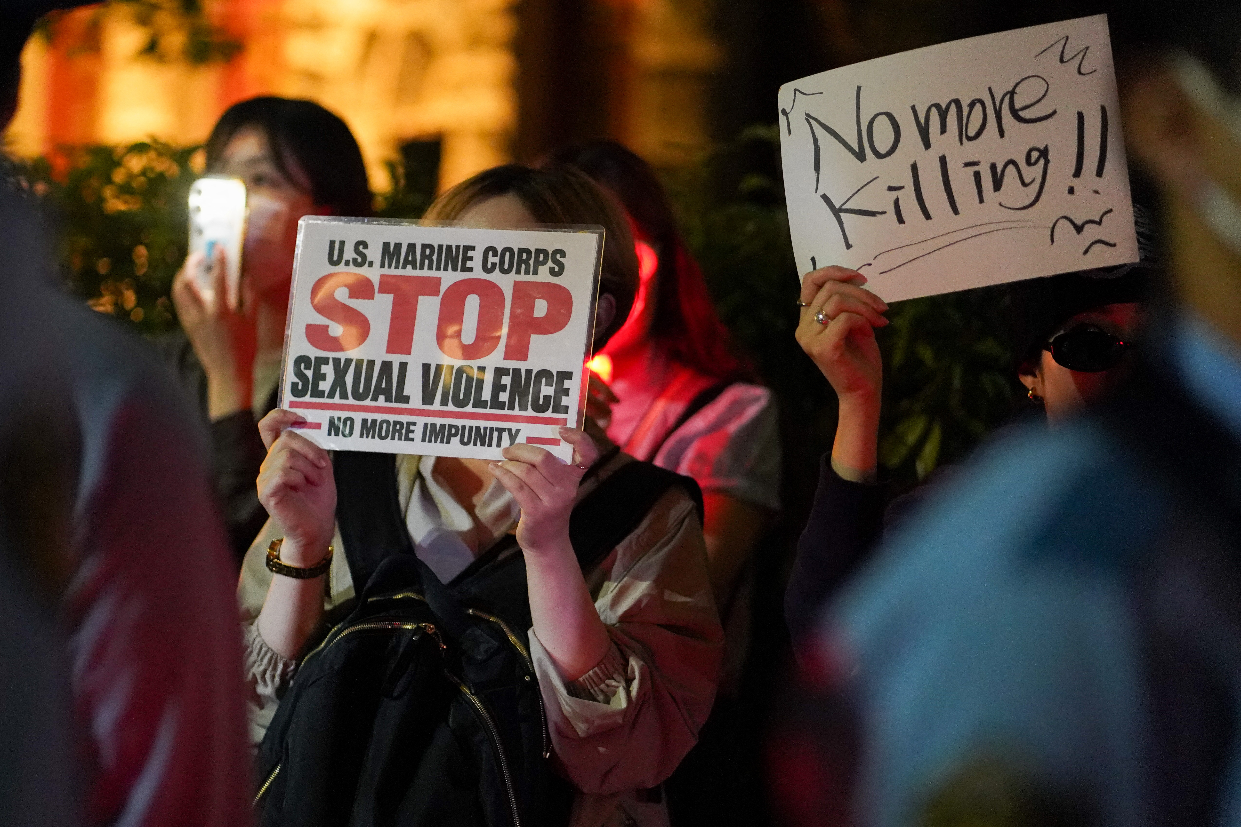 People protest against the killing of a woman in Okinawa allegedly committed by a US Marine, in front of the US Embassy in Tokyo on October 6, 2026.