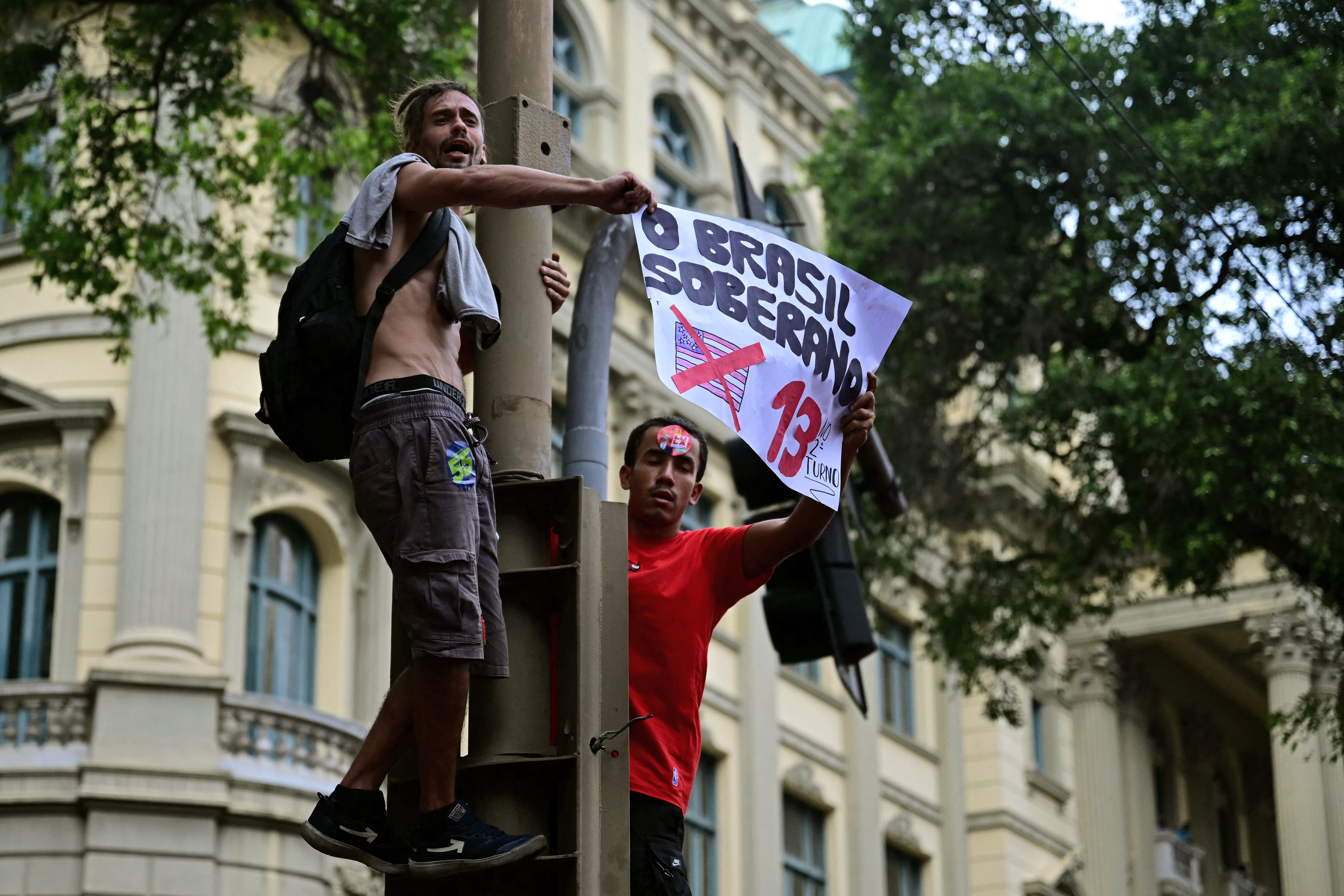 Students backing Brazil's President and presidential candidate Luiz Inacio Lula da Silva for the runoff election hold a sign during a march against the far right, in Rio de Janeiro, Brazil on October 7, 2026.