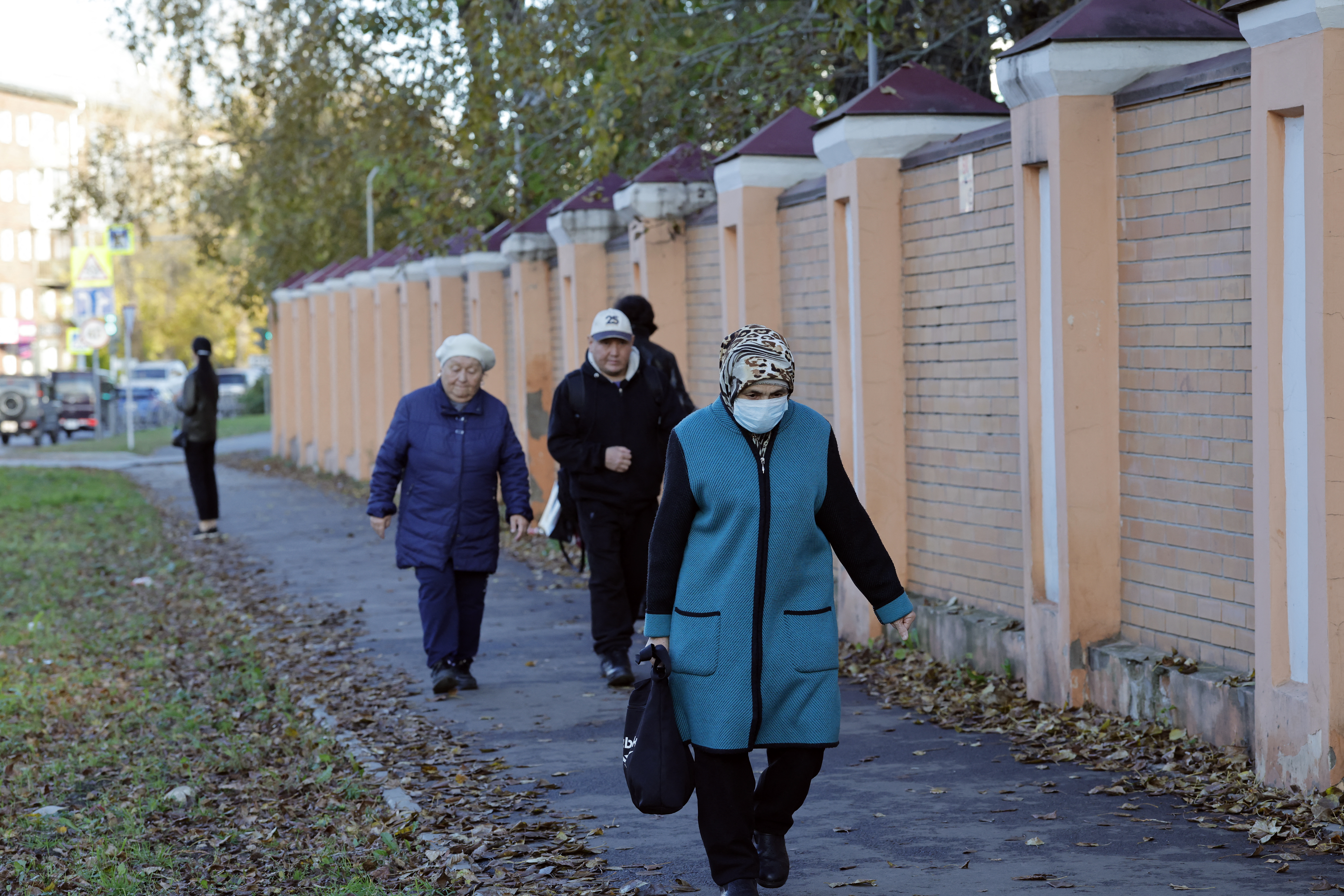 A woman wearing a face mask walks past the anti-plague institute in the city of Irkutsk on October 7, 2026.
