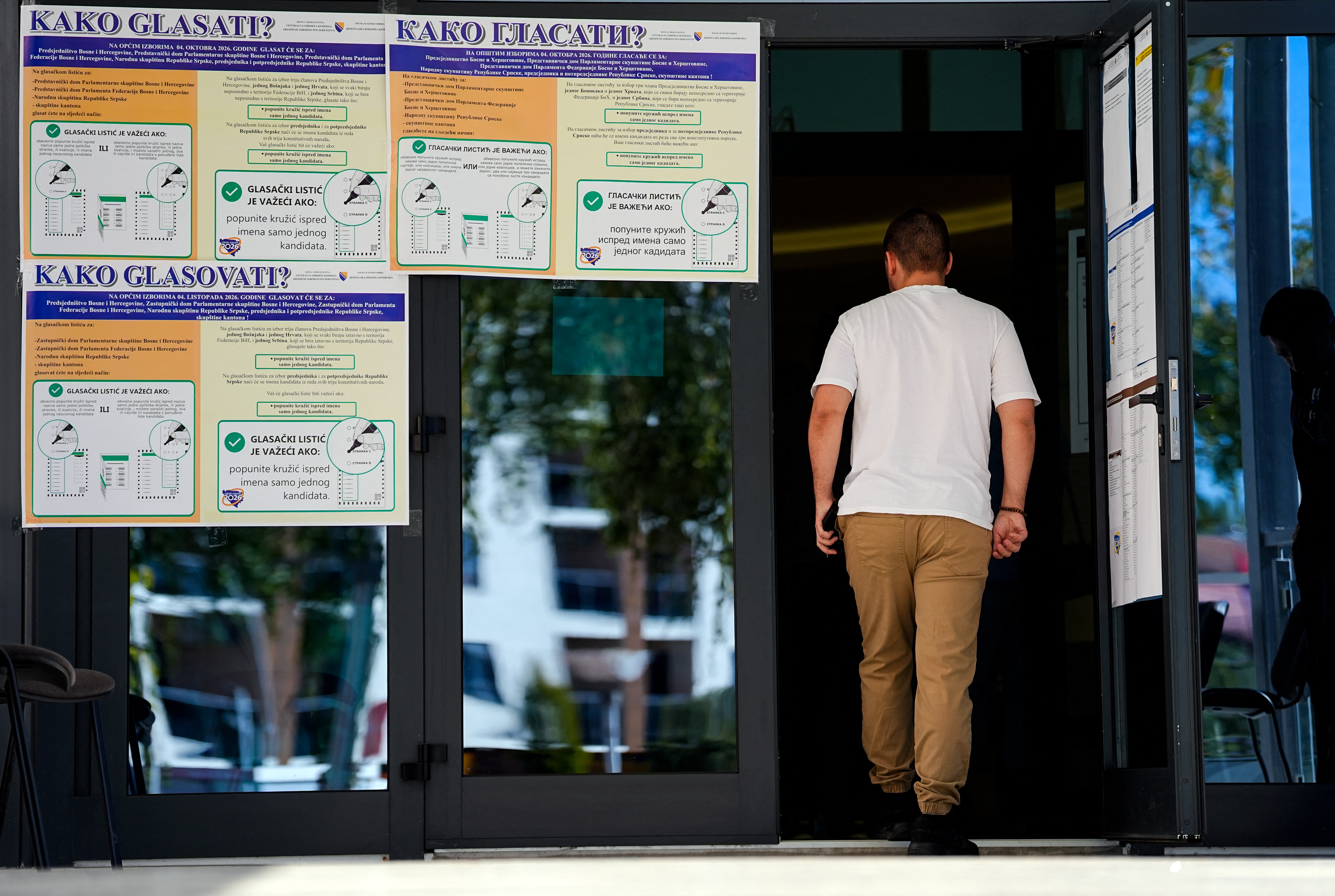 A voter enters at polling station with information panels on how to vote in Bosnian, Croatian, and Serbian during Bosnia and Herzegovina's general election in Laktasi, near Banja Luka, on October 4, 2026.
