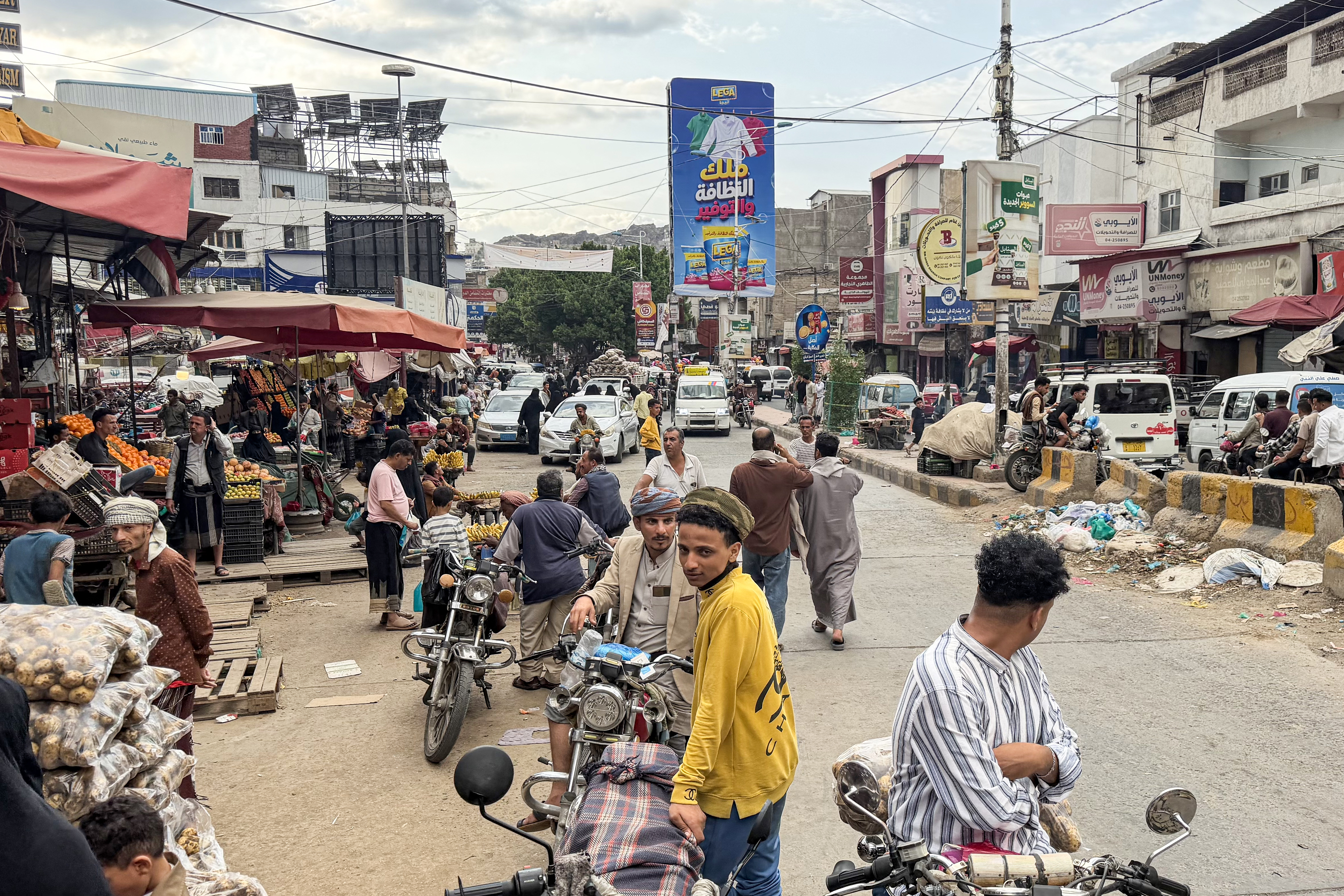 Yemeni people are seen at a local market in Yemen's southwestern city of Taiz on October 8, 2026.