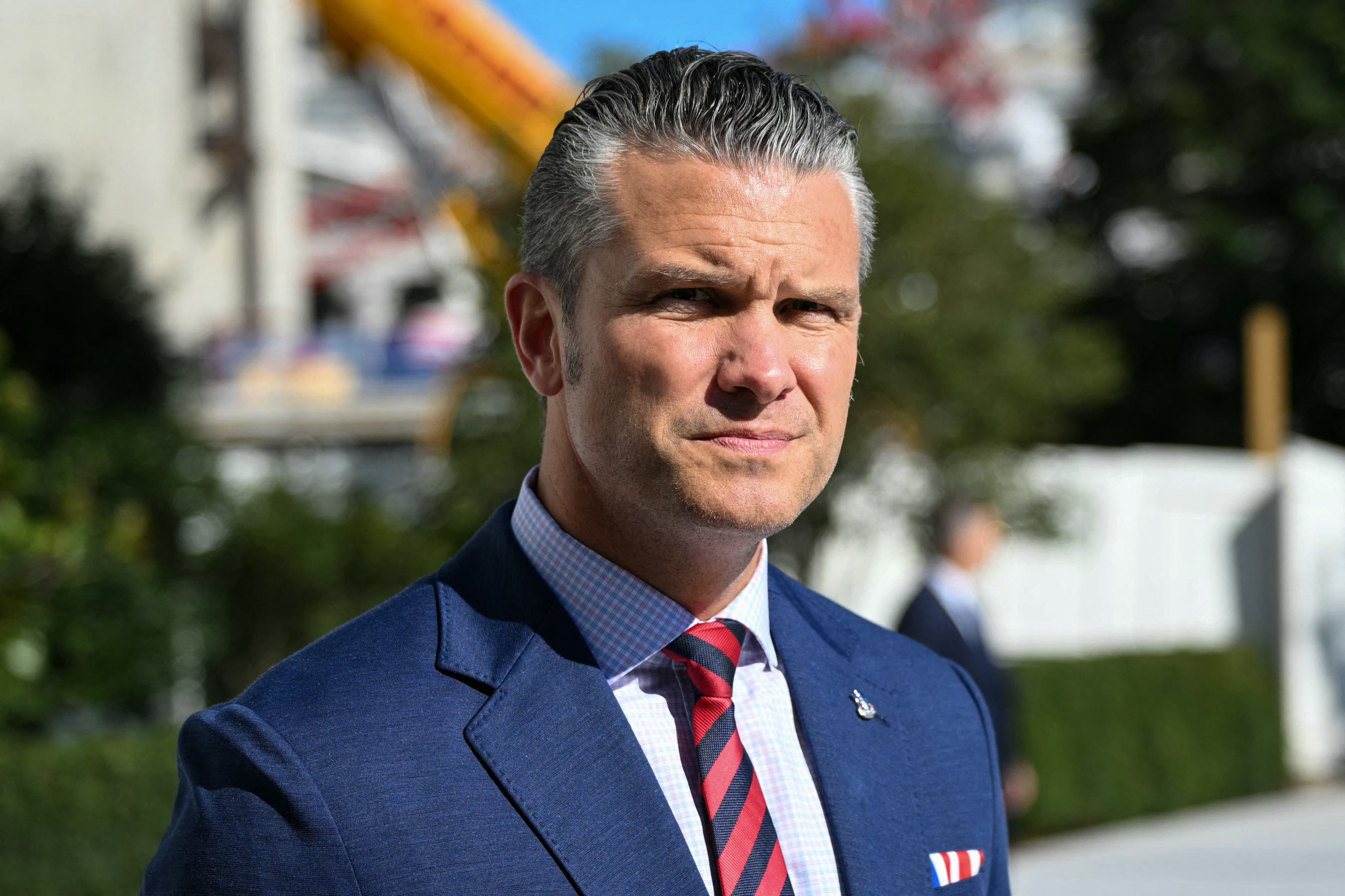 US Secretary of Defense Pete Hegseth looks on as US President Donald Trump (out of frame) speaks to the press before walking to board Marine One on the South Lawn of the White House in Washington, DC, on October 6, 2026.