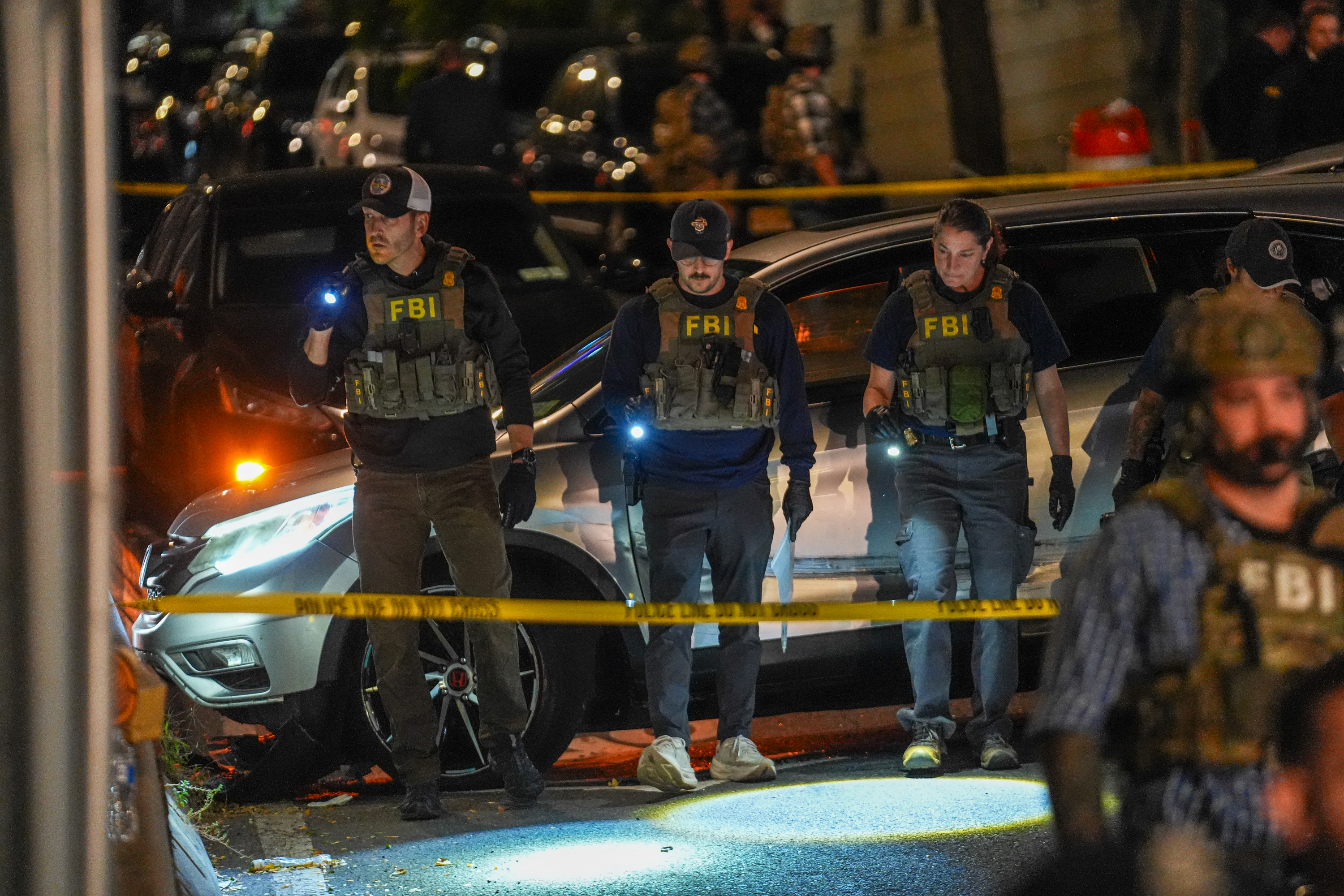 NEW YORK, NEW YORK - OCTOBER 8: Federal Bureau of Investigation (FBI) agents work at the scene where a man was allegedly shot by an Immigration and Customs Enforcement (ICE) officer during an operation in the Bronx borough of New York is seen on October 8, 2026, in New York City. According to local media and the NYPD, the driver was shot, conscious, and transported to a local hospital. Ryan Murphy/Getty Images/AFP (Photo by RYAN MURPHY / GETTY IMAGES NORTH AMERICA / Getty Images via AFP)