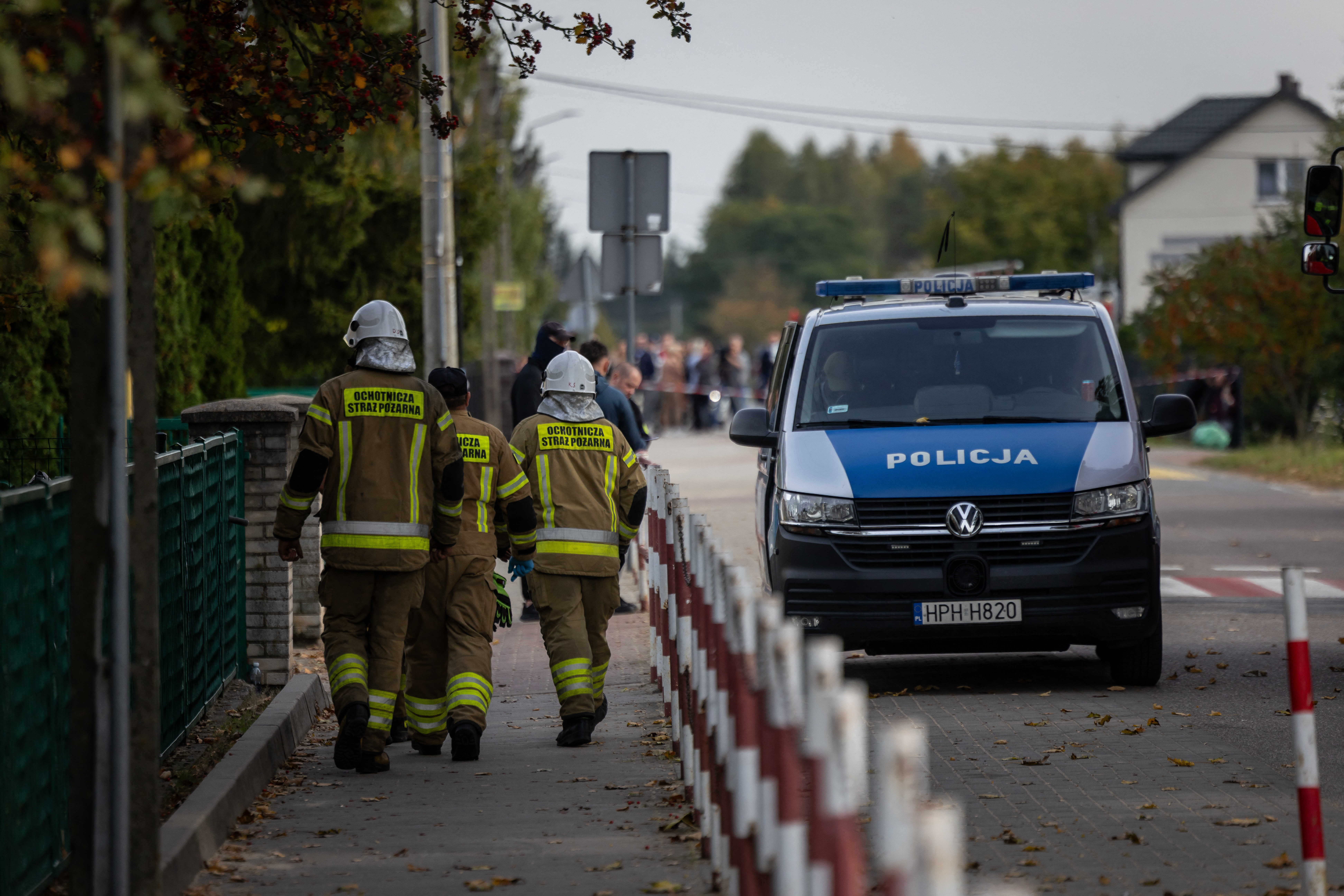 Police and other first responders work at the scene where a 15-year-old fatally stabbed the caretaker of his former school and wounded two other adults at the John-Paul II primary school in Leszczydol-Nowiny, Poland, on October 8, 2026, a day after a similar knife attack wounded nine in a Polish high school, police said.