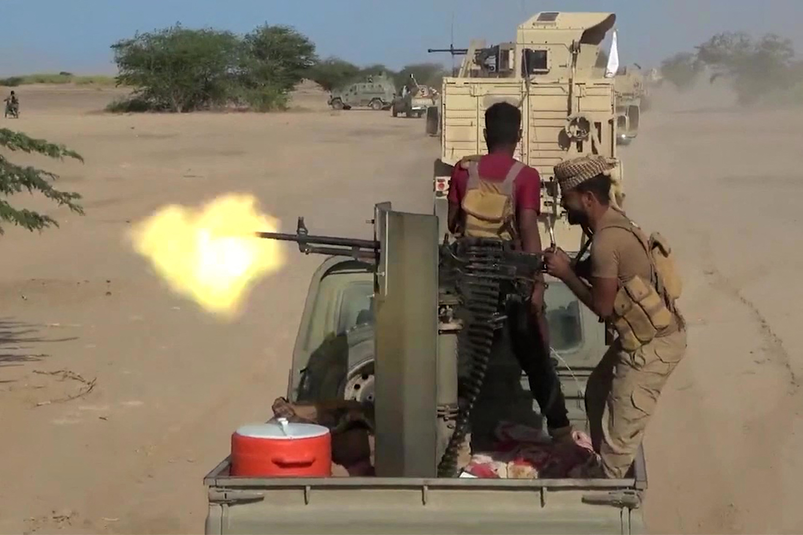 TOPSHOT - This screen grab taken from video footage released by the pro-Yemeni government Southern Giants Brigades on October 6, 2026 shows a fighter firing a turrent from the back of a "technical" pickup truck during clashes with Houthis near the Bab al-Mandeb Strait in Taiz province.