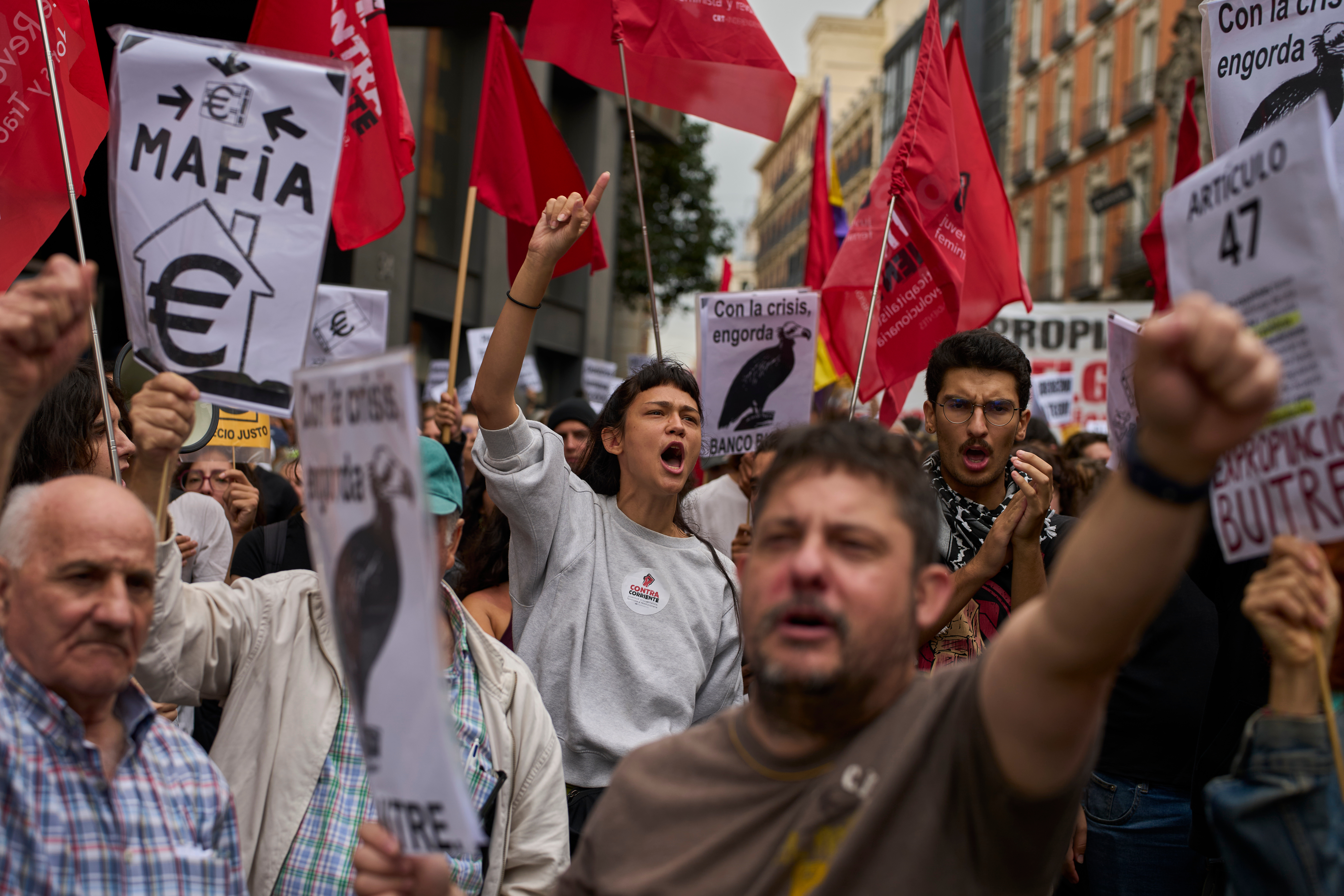 Activists protest near the Spanish Parliament following the eviction of 87-year-old Maricarmen to demand stronger laws to protect renters in Madrid, Spain, Friday, Oct. 2, 2026. (AP Photo/Manu Fernandez)