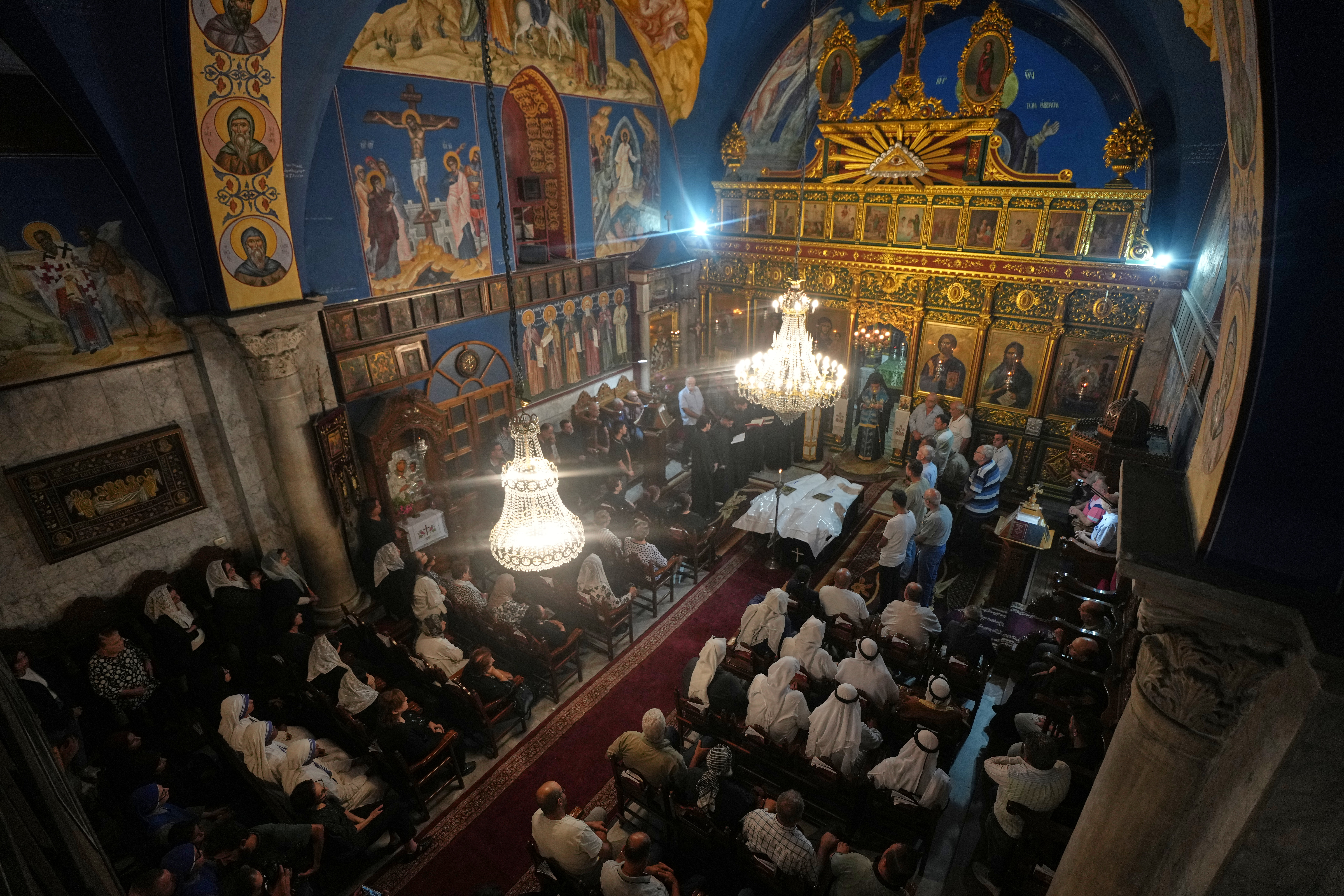 Mourners attend the funeral of Palestinians Maisaa Abu Dawood and her daughter Mary, who were killed in an early morning Israeli airstrike, at the Church of St. Porphyrius in Gaza City, Saturday, Oct. 3, 2026. (AP Photo/Jehad Alshrafi)