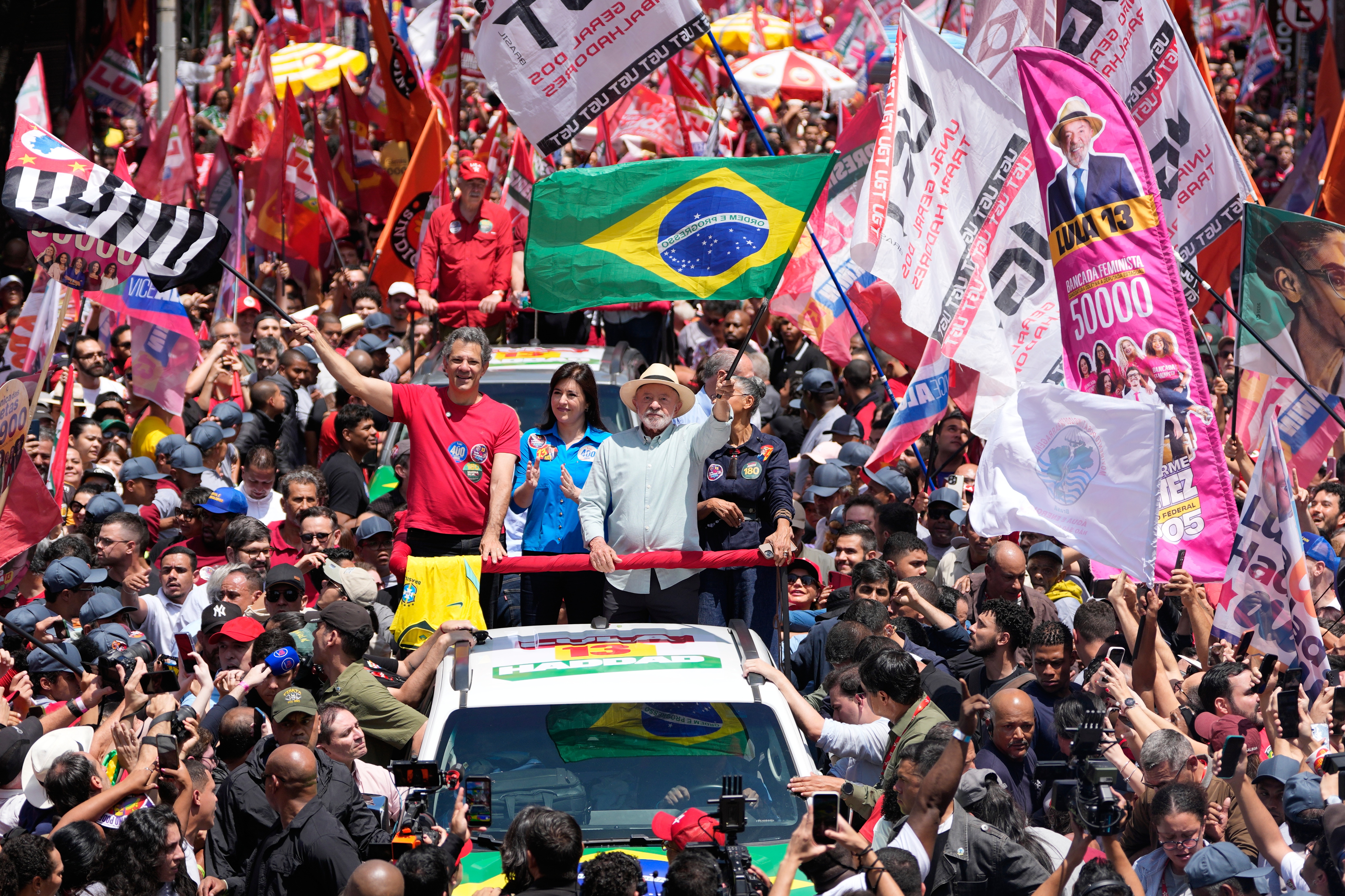 President Luiz Inacio Lula da Silva, who is running for reelection, waves a Brazilian flag during a campaign rally a day ahead of the country's general election in Sao Paulo, Saturday, Oct. 3, 2026. (AP Photo/Andre Penner)