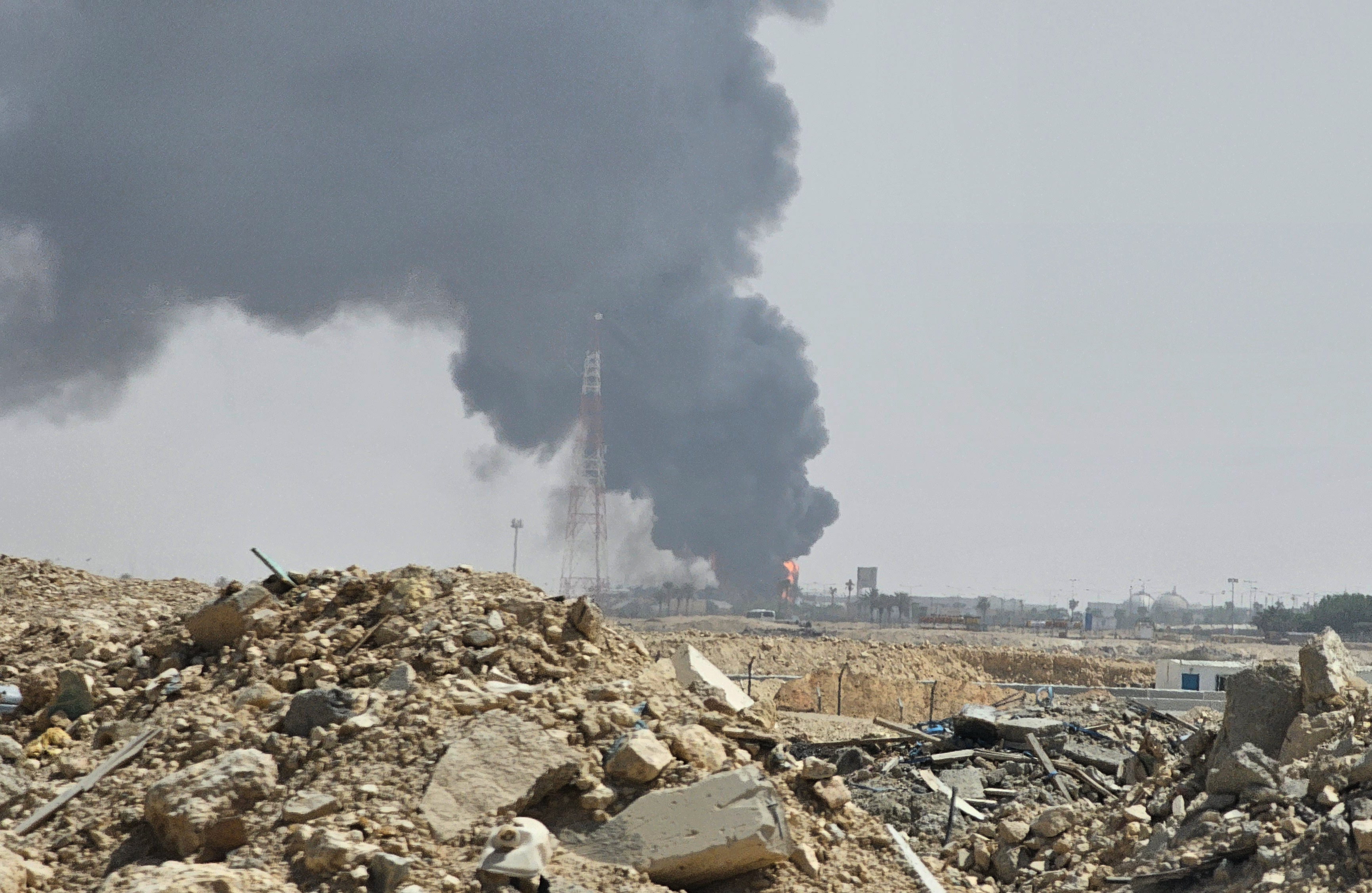 Black smoke and flames rise from an oil facility in Riyadh, Saudi Arabia