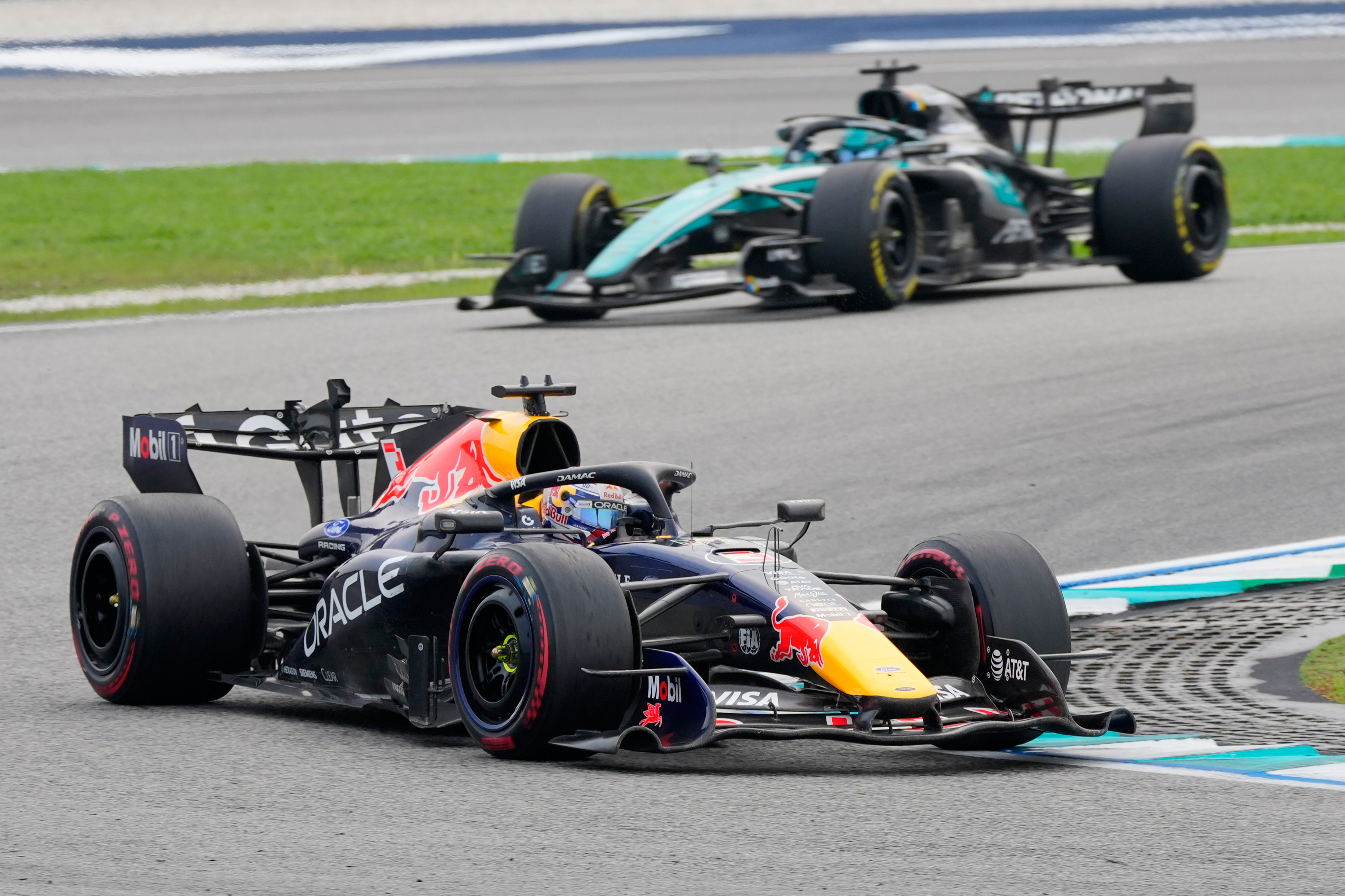 Red Bull driver Max Verstappen of the Netherlands steers his car ahead of Mercedes drivers George Russell of Britain during the Bahrain Grand Prix in Sepang, Malaysia