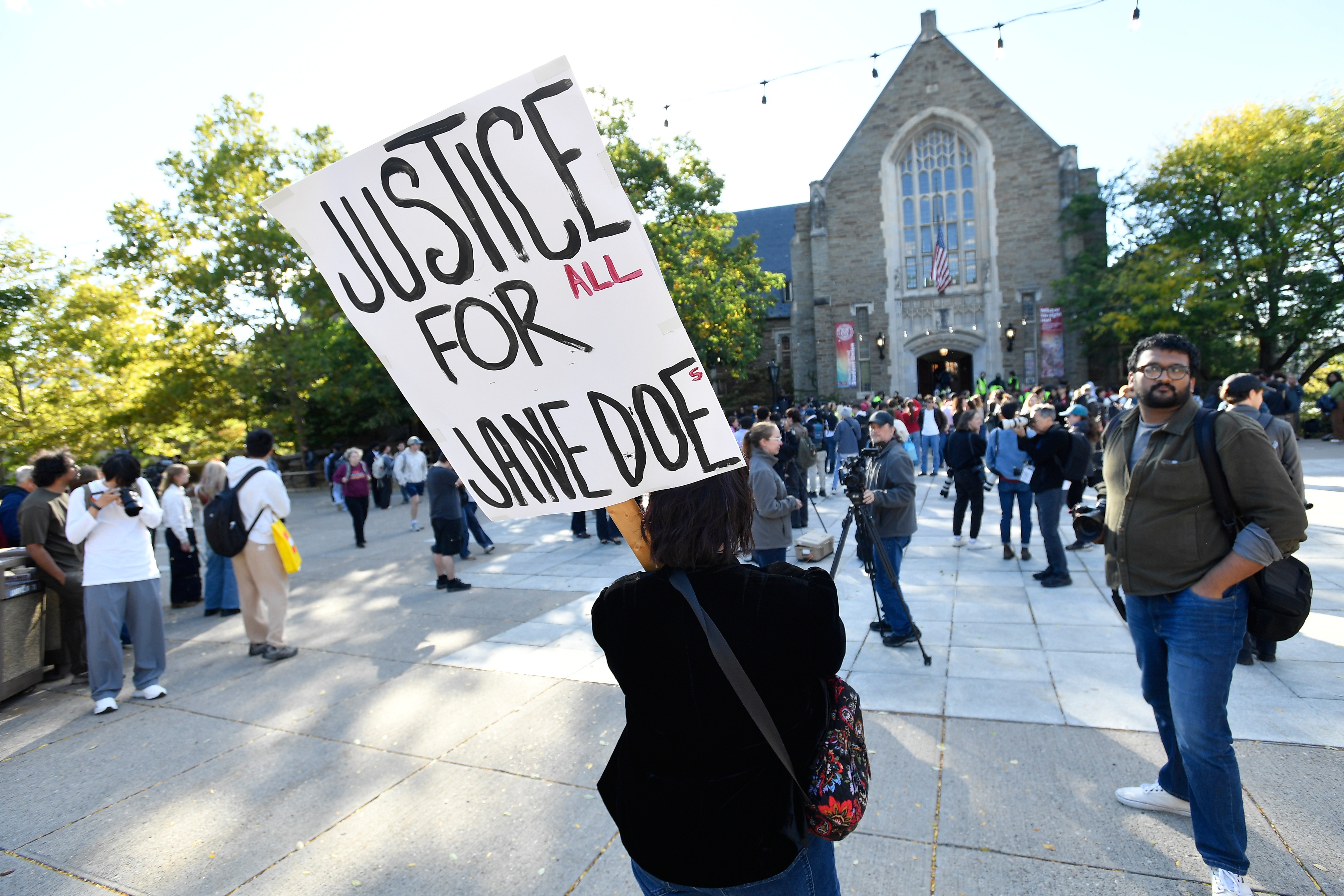 An attendee holds a sign in support of Jane Doe during a protest at Cornell University, Monday, Oct. 5, 2026, in Ithaca, N.Y. (AP Photo/Adrian Kraus)