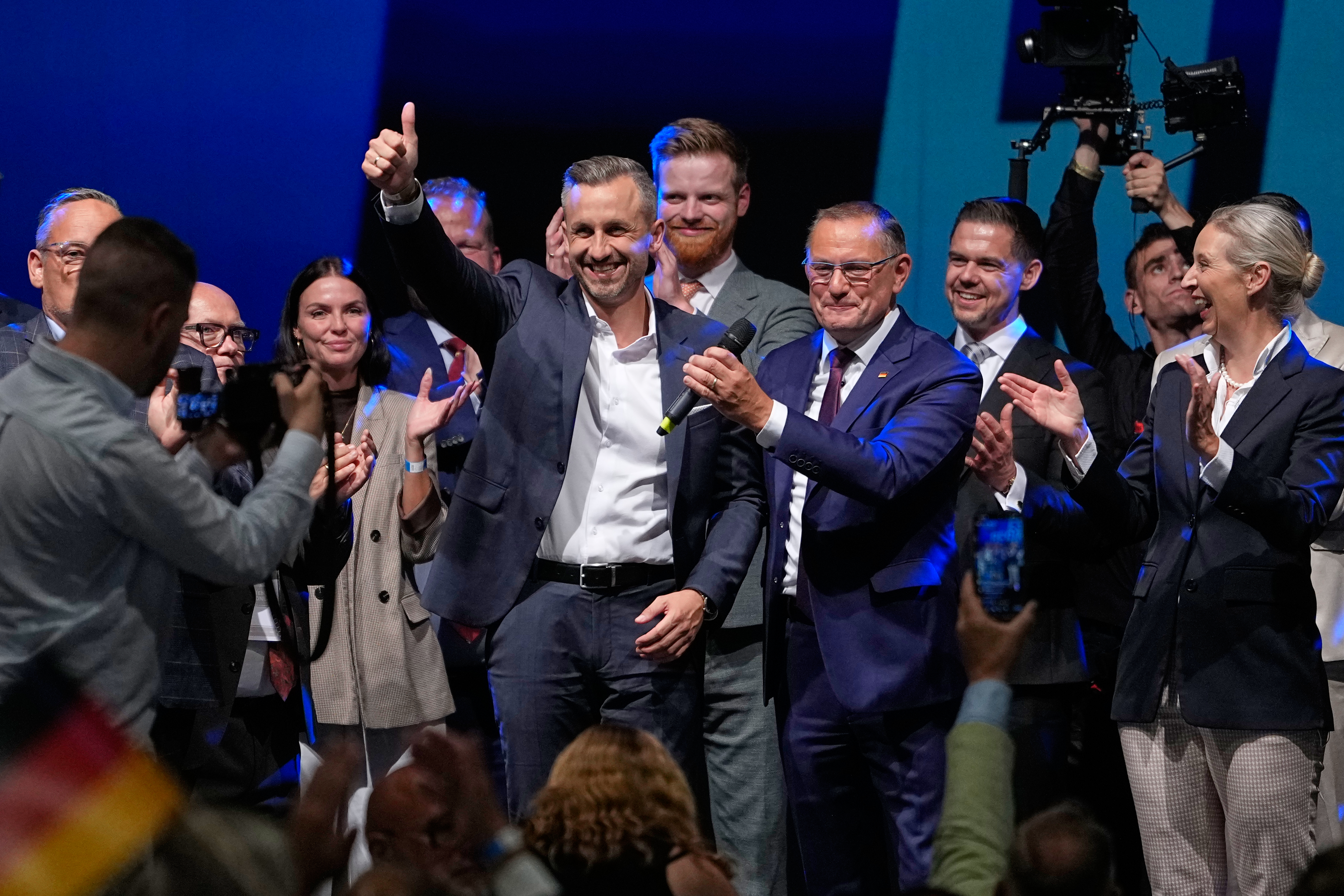 File - Top candidate Ulrich Siegmund shows thumbs up beside party leaders Tino Chrupalla and Alice Weidel, from left, at an election party of the "Alternative for Germany" (AfD) after the Saxony-Anhalt state elections in Magdeburg, eastern Germany, Sept. 6, 2026. (AP Photo/Matthias Schrader, File)