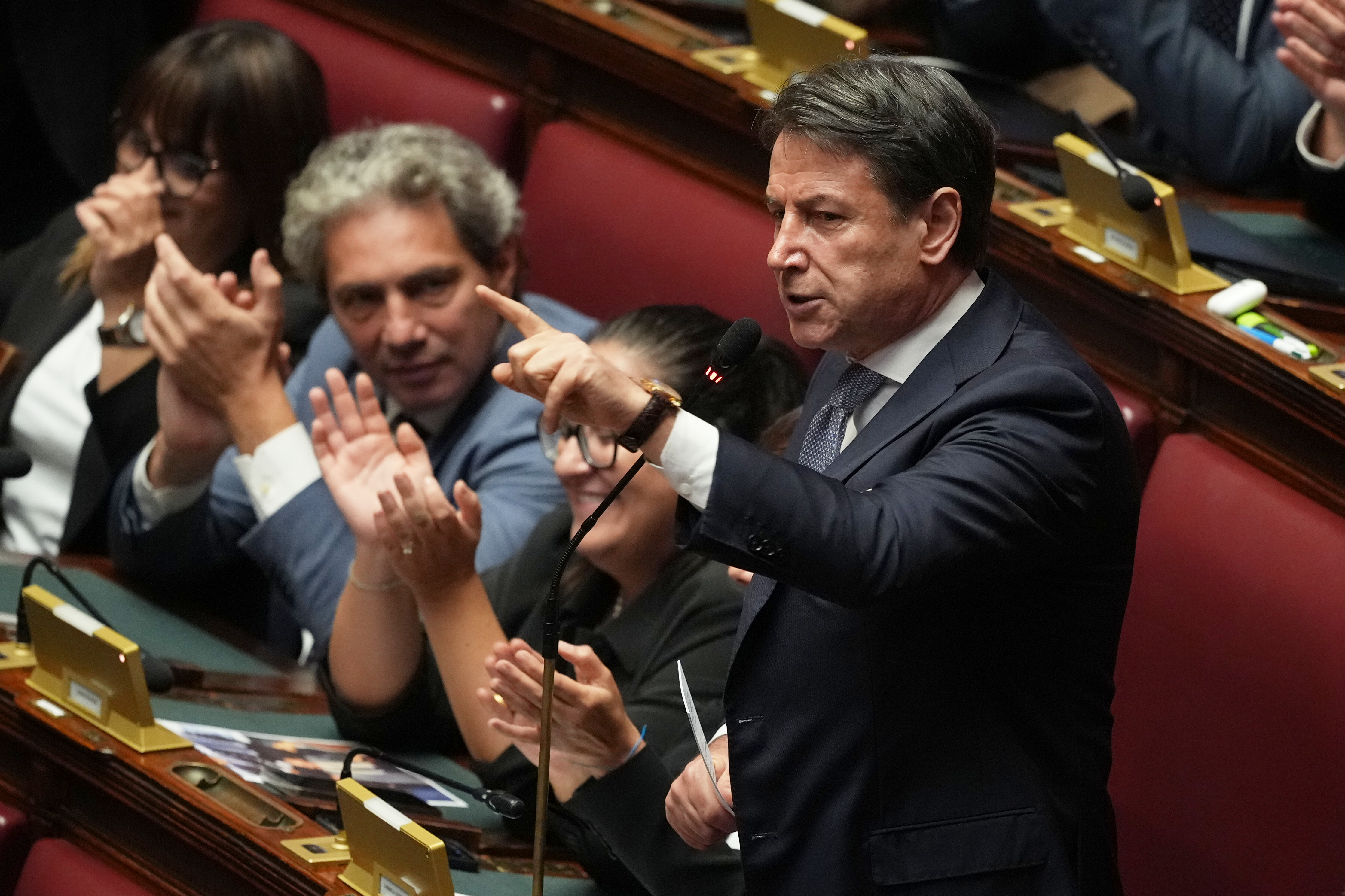 Italian Five Star Movement leader Giuseppe Conte gestures as he delivers a speech.