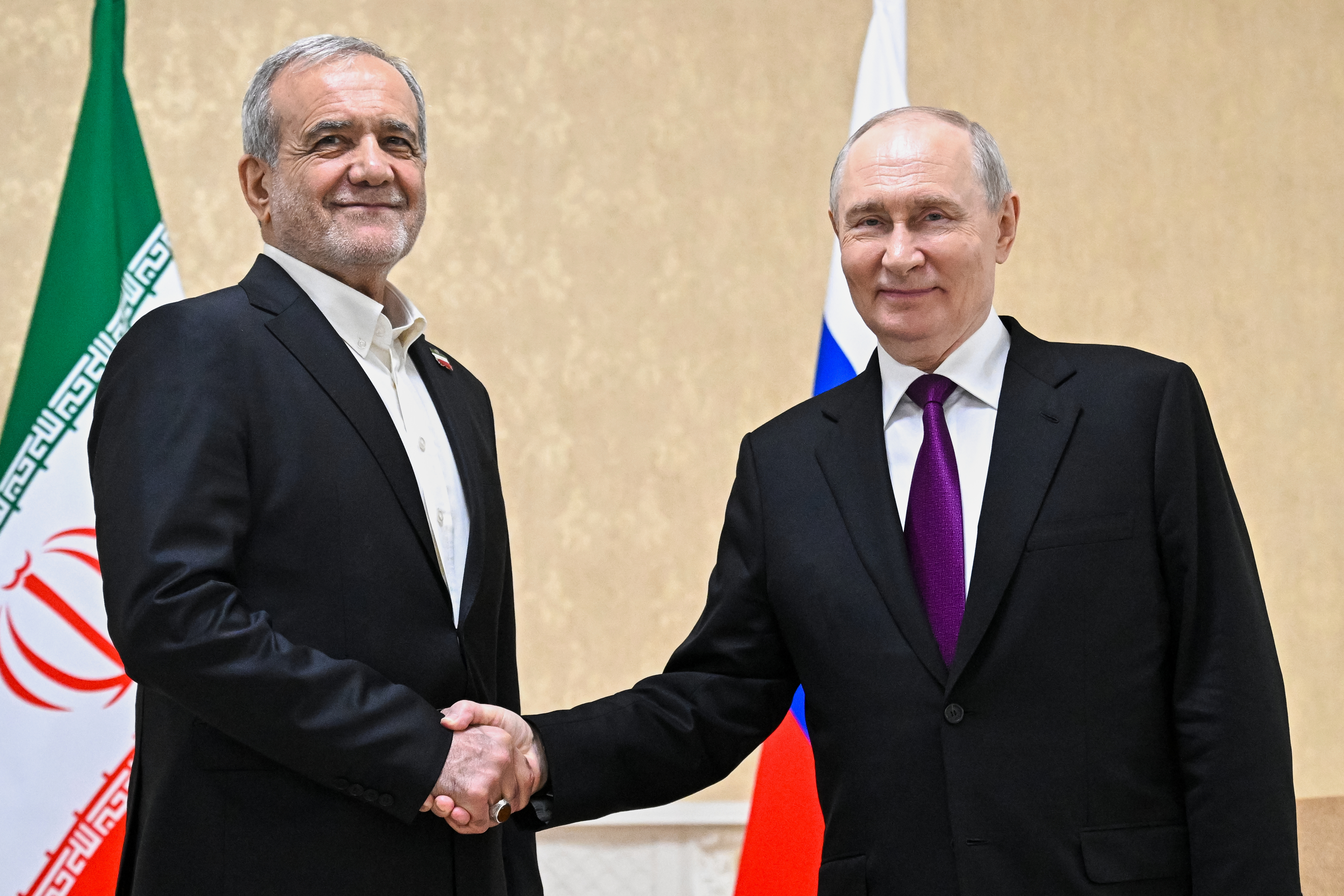 Russian President Vladimir Putin, right, and Iranian President Masoud Pezeshkian pose for a photo on the sidelines of the Commonwealth of Independent States (CIS) summit in Türkmenbaşy, Turkmenistan, Thursday, Oct. 8, 2026. (Sergei Bobylev, Sputnik, Kremlin Pool Photo via AP)