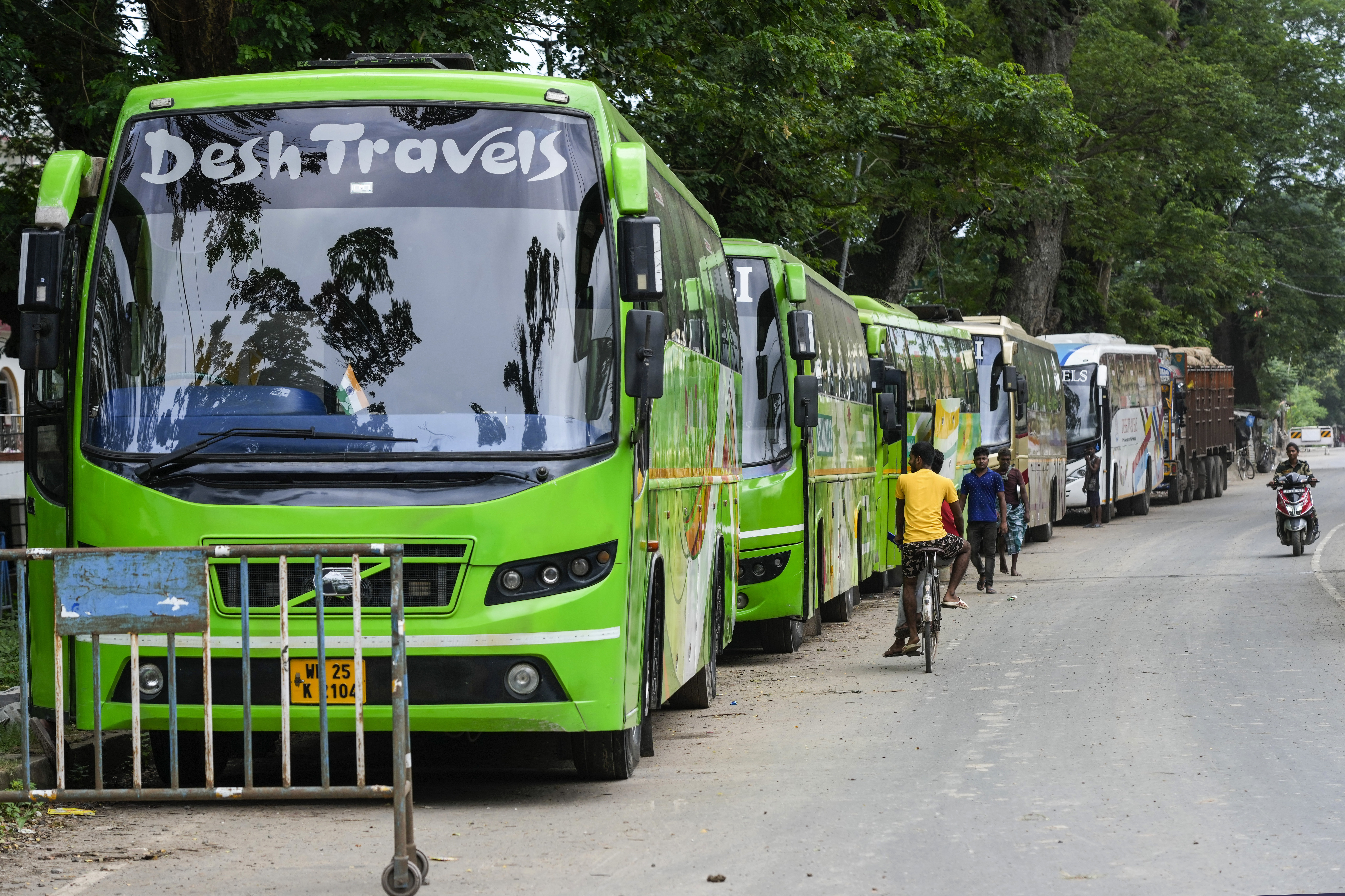 Buses are parked near a border post with Bangladesh due to less passengers coming towards India, in Petrapole, India, Sunday, July 21, 2024. (AP Photo/Bikas Das)