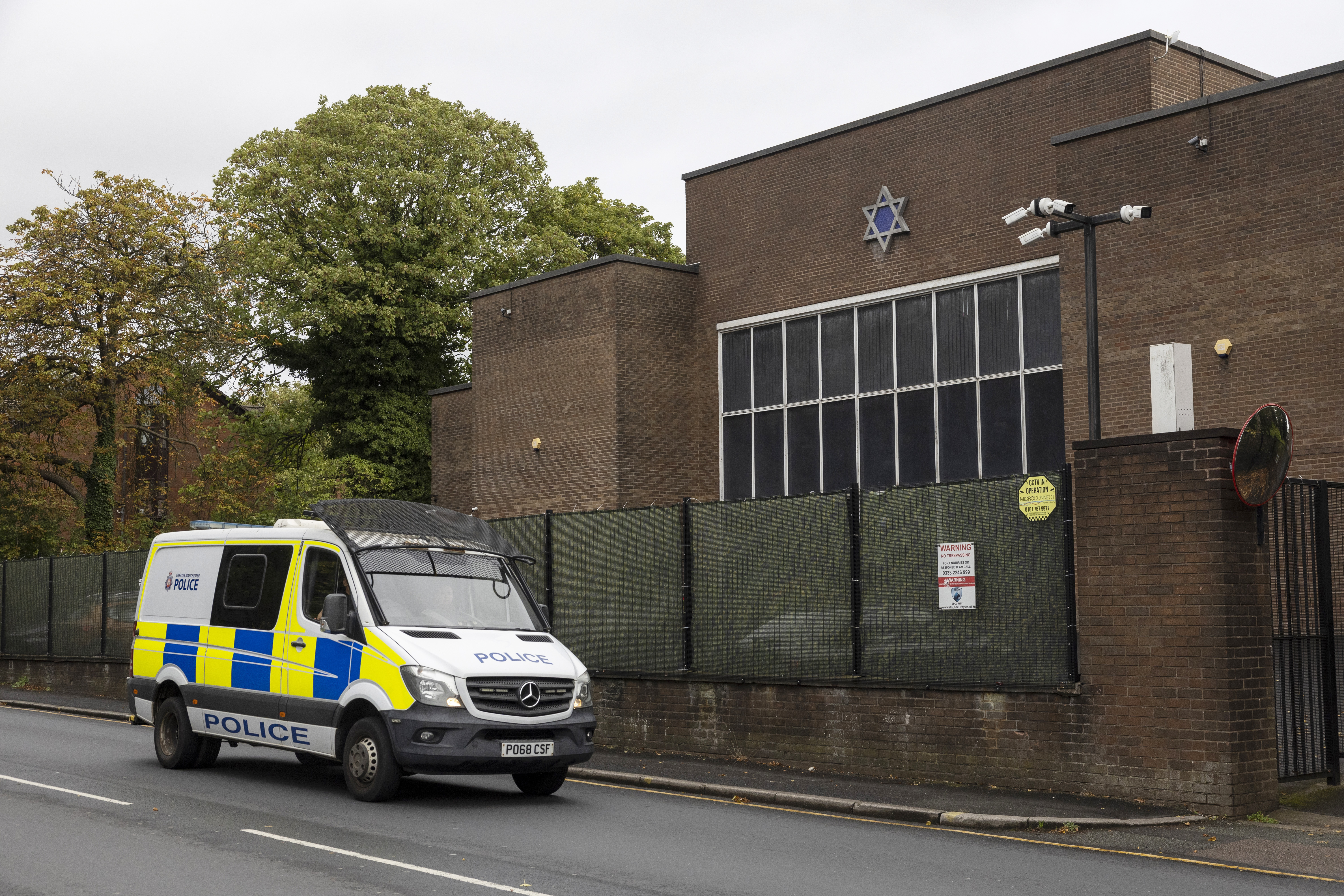 MANCHESTER, ENGLAND - OCTOBER 02: A police car patrols the area around Heaton Park Shul on October 02, 2026 in Manchester, England. Jewish communities across the UK remain on high alert one year after a deadly terrorist attack on the Heaton Park Synagogue in Manchester. On October 2, 2025, Syrian-born British citizen Jihad al-Shamie rammed his car into worshippers and carried out a knife attack at the synagogue during the Jewish holiday of Yom Kippur. Two members of the congregation died in the attack; Melvin Cravitz, 66, was killed by Al-Shamie, while Adrian Daulby, 53, was accidentally shot by police responding to the attack. Members of the synagogue marked the anniversary of the attack on Yom Kippur, which fell on September 21 in the Hebrew calendar this year. (Photo by Ryan Jenkinson/Getty Images)