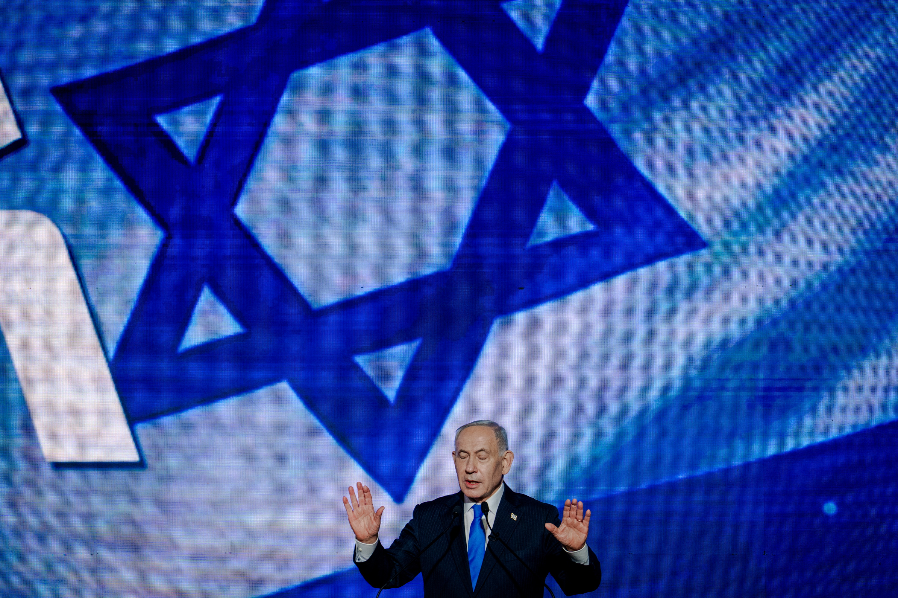 TEL AVIV, ISRAEL - SEPTEMBER 17: Israeli Prime Minister and Likud party leader Benjamin Netanyahu raises both hands with open palms while delivering remarks from the lectern to supporters during a party campaign rally at Expo Tel Aviv on September 17, 2026 in Tel Aviv, Israel. The right-wing Likud party, led by Prime Minister Benjamin Netanyahu, is seeking to retain power in Israel's upcoming national election, due to be held on October 27. Recent polling suggests Likud and the ruling coalition face a tight race against opposition blocs, with no clear frontrunner emerging in an increasingly fragmented political landscape. The election is the first to be held since Israel went to war in Gaza, Lebanon and Iran, in the aftermath of the Hamas terror attacks on October 7, 2023. (Photo by Erik Marmor/Getty Images)