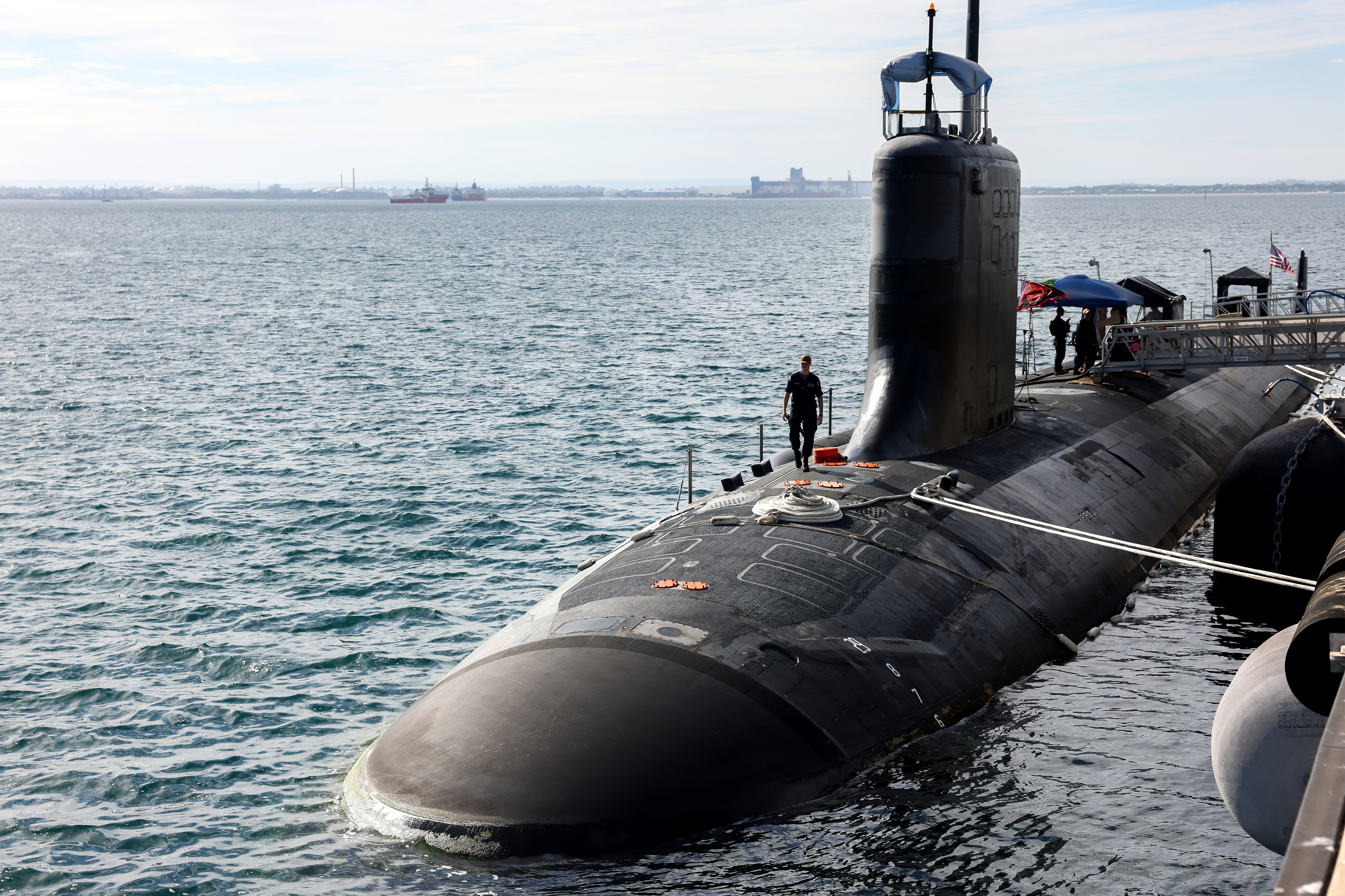 ROCKINGHAM, AUSTRALIA - FEBRUARY 26: U.S. Navy officers stand guard aboard Virginia-class fast attack submarine USS Minnesota (SSN-783) after the vessel docked at HMAS Stirling on February 26, 2025 in Rockingham, Australia. The submarine was on a port visit. (Photo by Colin Murty - Pool/Getty Images)