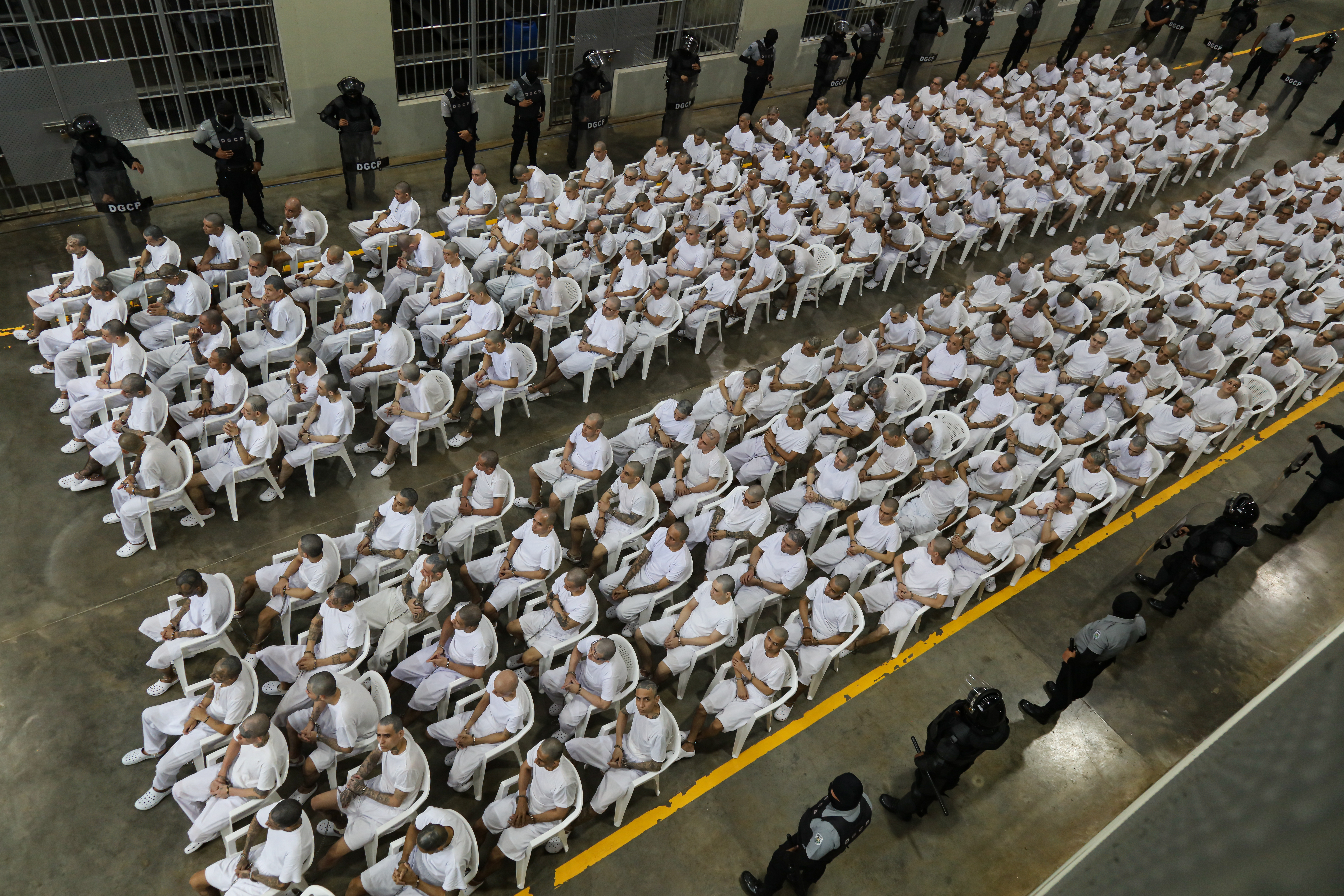 TECOLUCA, EL SALVADOR - APRIL 23: Prison inmates listen during a massive hearing against criminals and gang members at CECOT on April 23, 2026 in Tecoluca, El Salvador. In 2023, El Salvador opened Latin America's largest prison as part of President Nayib Bukele's plan to fight gangs. The government says some 20,000 gang members are being held at the mega-prison, which has a capacity of 40,000. (Photo by Alex Peña/Getty Images)