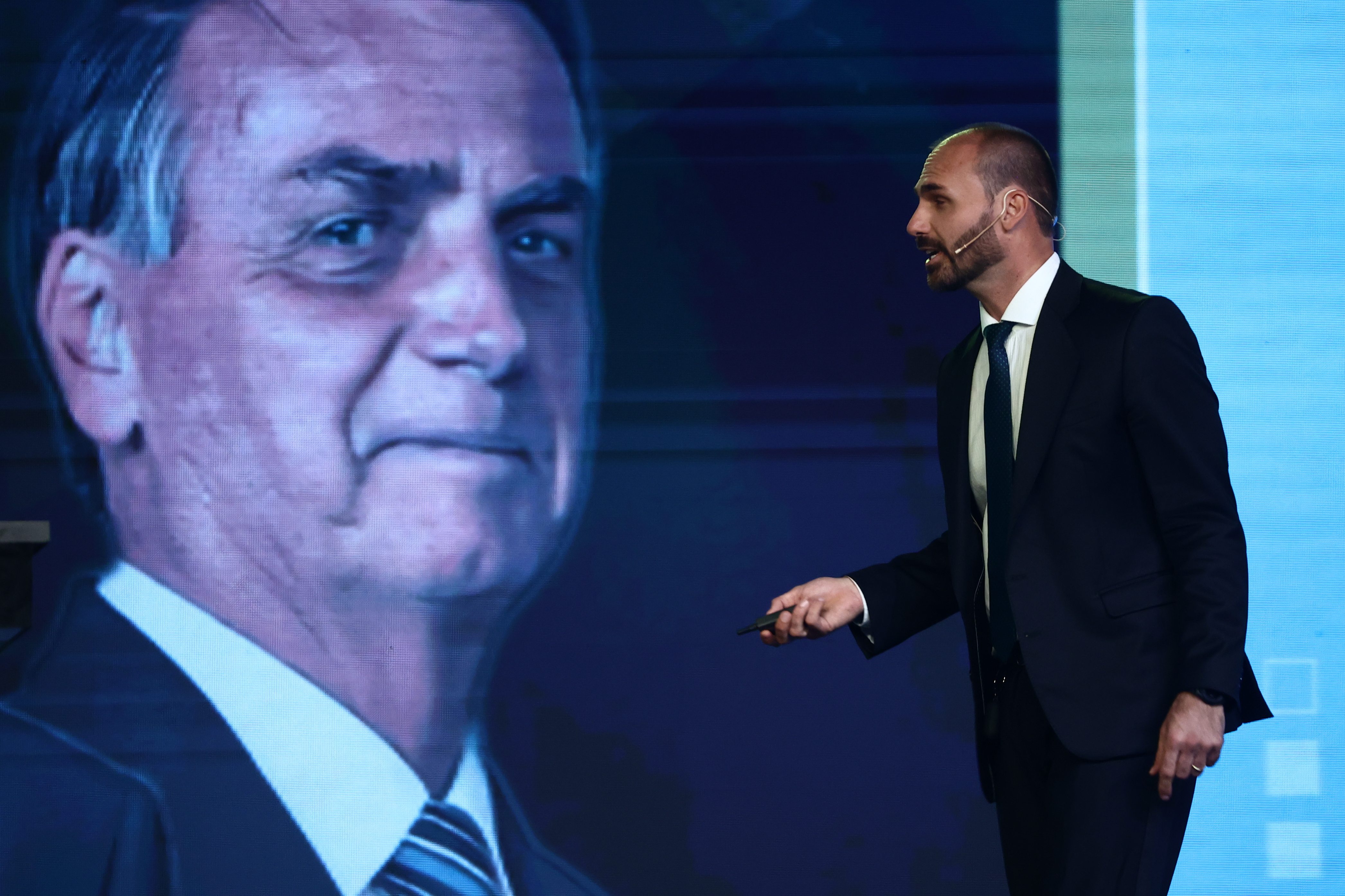 BUENOS AIRES, ARGENTINA - DECEMBER 04: Member of the Brazilian Chamber of Deputies Eduardo Bolsonaro speaks next to an image of his father, former Brazilian President Jair Bolsonaro during the CPAC Argentina 2024, Conservative Political Action Conference, on December 04, 2024 in Buenos Aires, Argentina. The CPAC is considered the largest and most influential forum of conservatives and ultra liberals in the world. (Photo by Tomas Cuesta/Getty Images)