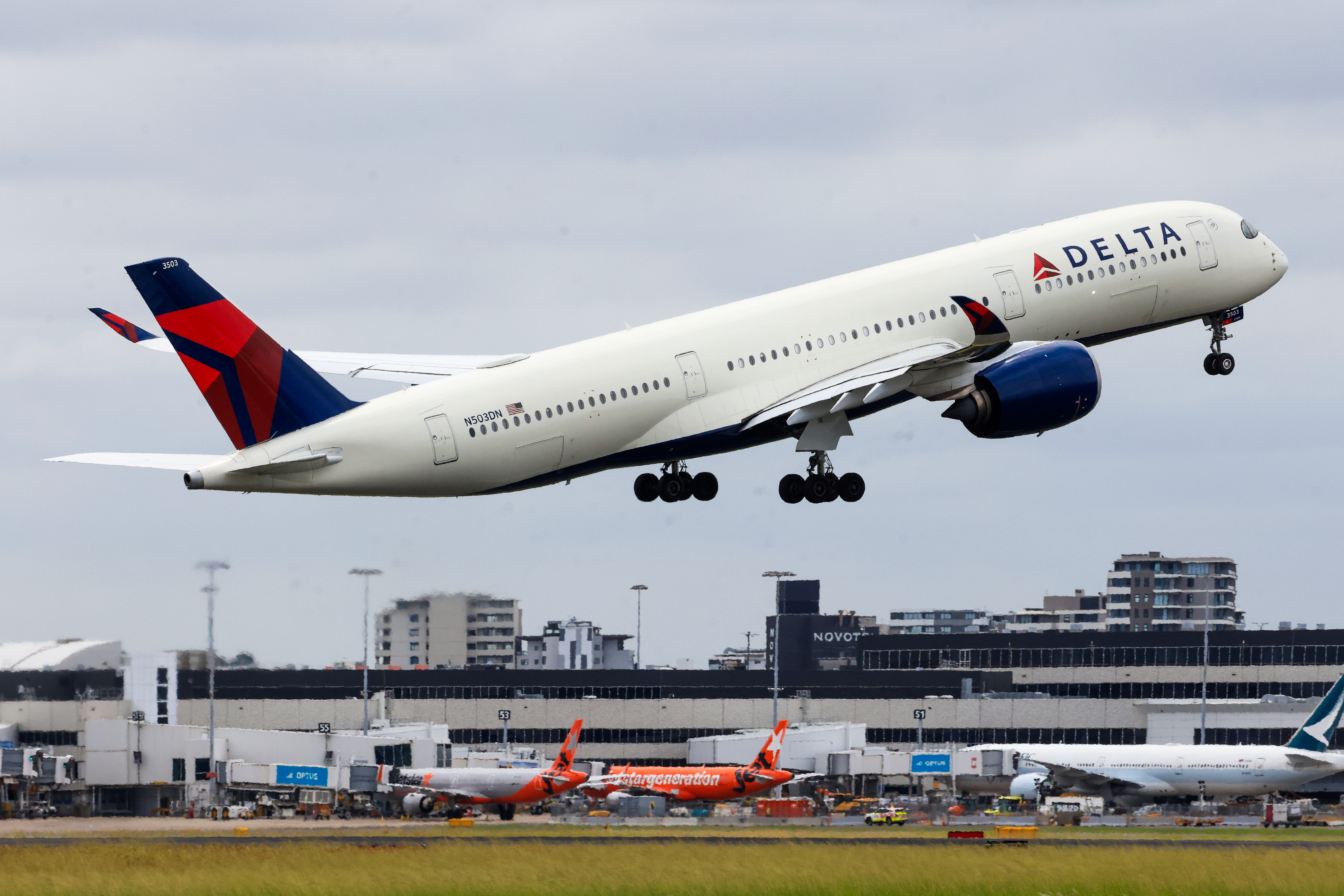 SYDNEY, AUSTRALIA - JANUARY 20: A Delta Air plane takes off from Sydney Airport on January 20, 2024 in Sydney, Australia. Transport Minister Catherine King signed off on a deal that will allow Turkish Airlines to start serving the Australian market, rising to 35 flights a week by 2025. The decision came as the government was under mounting criticism from many for a perception that it was protecting the profits of Qantas and stymying competition in the market by limiting additional capacity for other carriers, such as Qatar Airways. (Photo by Jenny Evans/Getty Images)