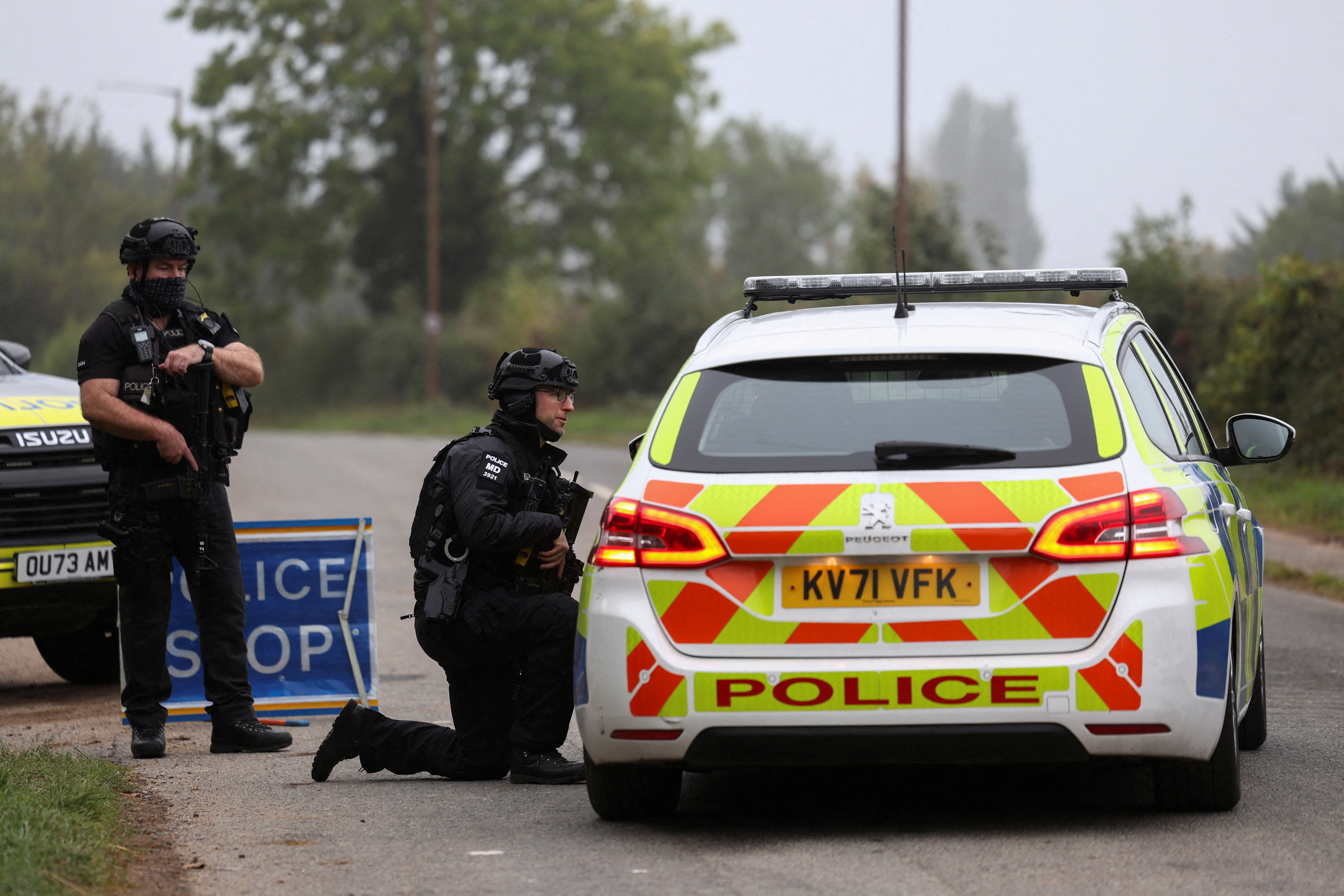 Police officers guard an area as roadblocks remain in place near RAF Fairford airbase, after police declared a major incident at the base and arrested several men on suspicion of offences under the Explosives Act, who have since been released on bail, in Fairford, Gloucestershire, Britain, September 29, 2026. REUTERS/Toby Shepheard TPX IMAGES OF THE DAY