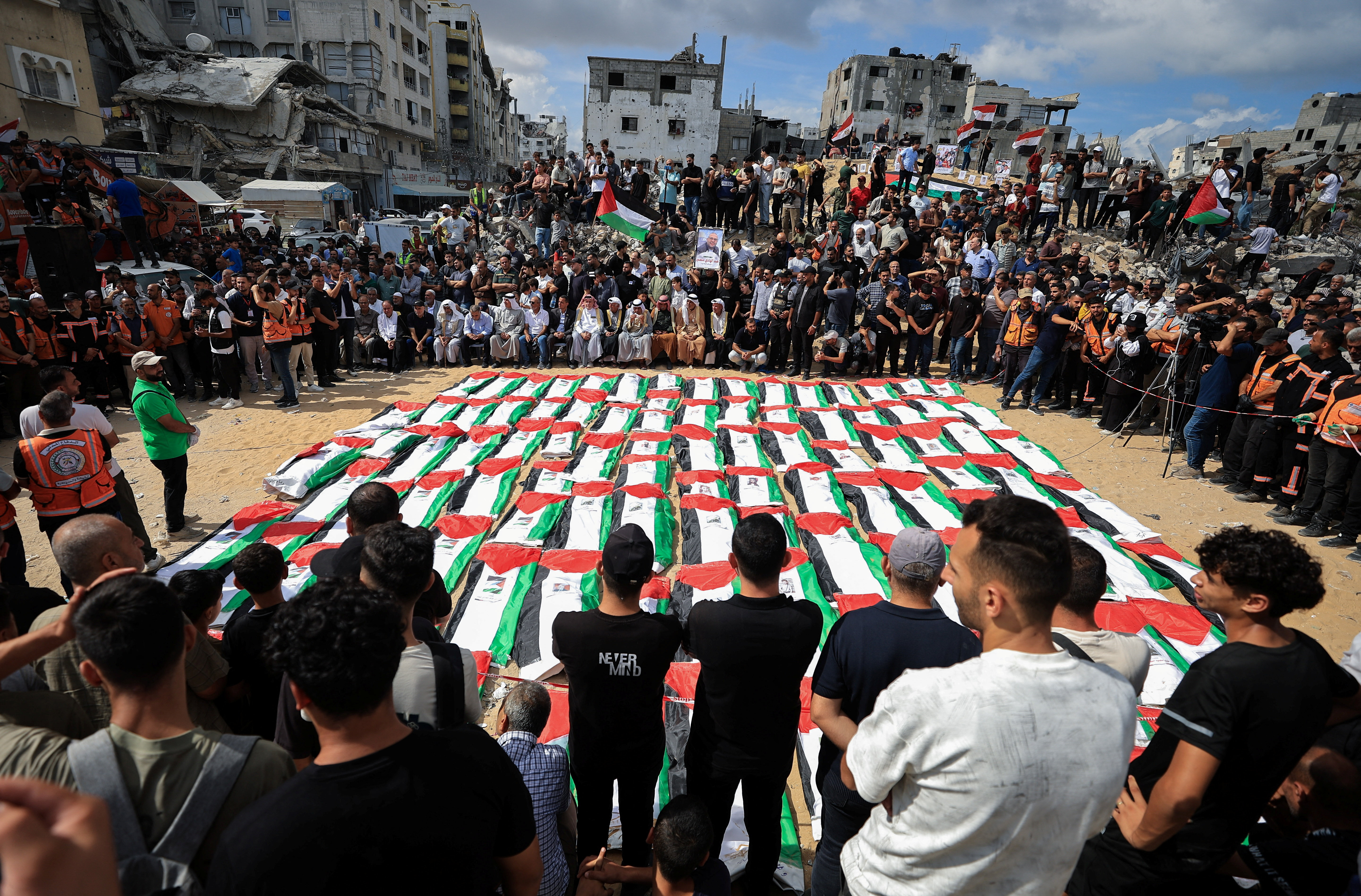 Mourners attend a mass funeral for Palestinians whose bodies were recovered from the rubble of a residential building hit in an Israeli strike in October 2023, according to the Civil Defence, in Gaza City October 1, 2026. REUTERS/Dawoud Abu Alkas