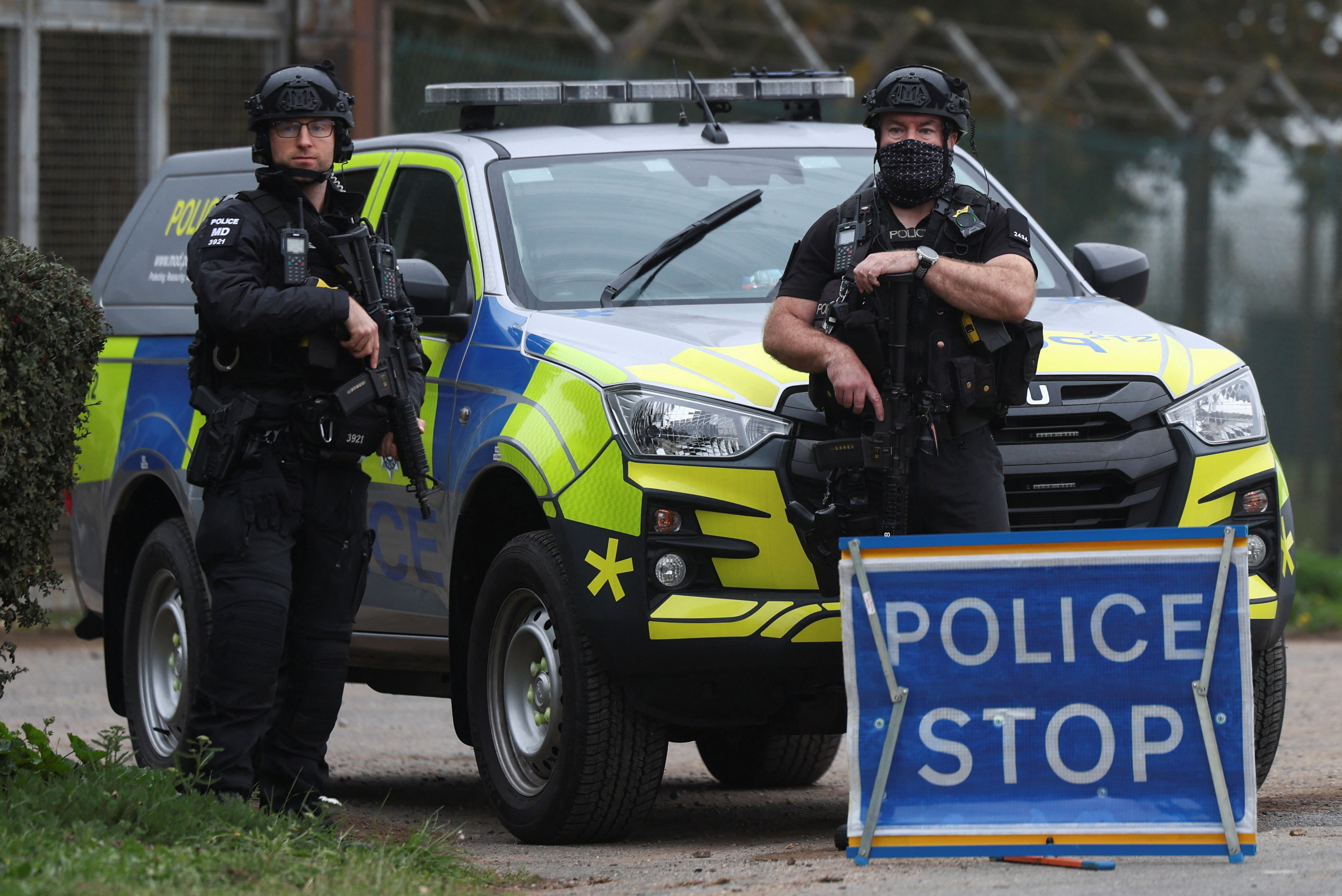Police officers guard an area as roadblocks remain in place near RAF Fairford airbase, after police declared a major incident at the base and arrested several men on suspicion of offences under the Explosives Act, who have since been released on bail, in Fairford, Gloucestershire, Britain, September 29, 2026. REUTERS/Toby Shepheard