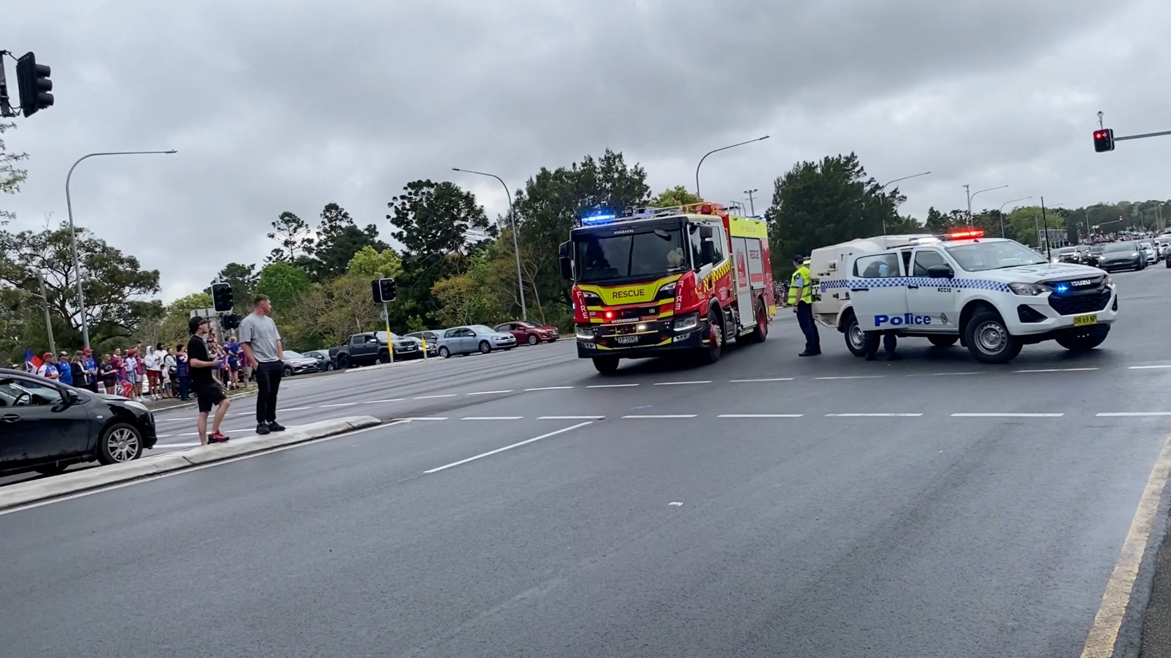 A fire truck drives towards a crash site as a police vehicle blocks a road, after a car drove into a crowd, in Wallsend, News South Wales, October 3, 2026, in this picture obtained from social media. Kai Preston/via REUTERS THIS IMAGE HAS BEEN SUPPLIED BY A THIRD PARTY. MANDATORY CREDIT. NO RESALES. NO ARCHIVES. VERIFICATION: - Date and location verified by metadata on original file - Traffic lights, signboards and road layout matched archive imagery