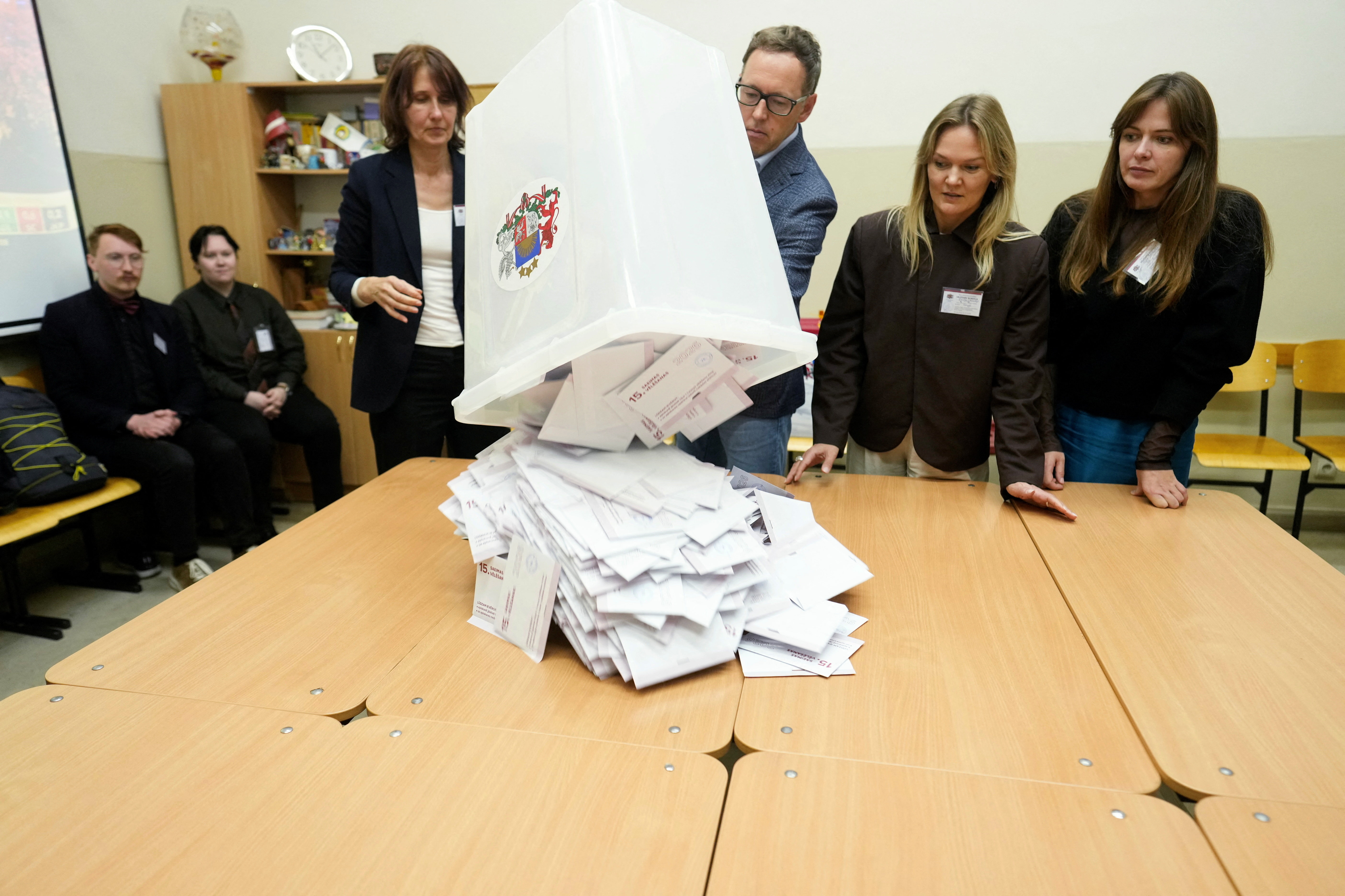 Election district officials open a ballot box during the general election in Riga, Latvia, October 3, 2026. REUTERS/Ints Kalnins