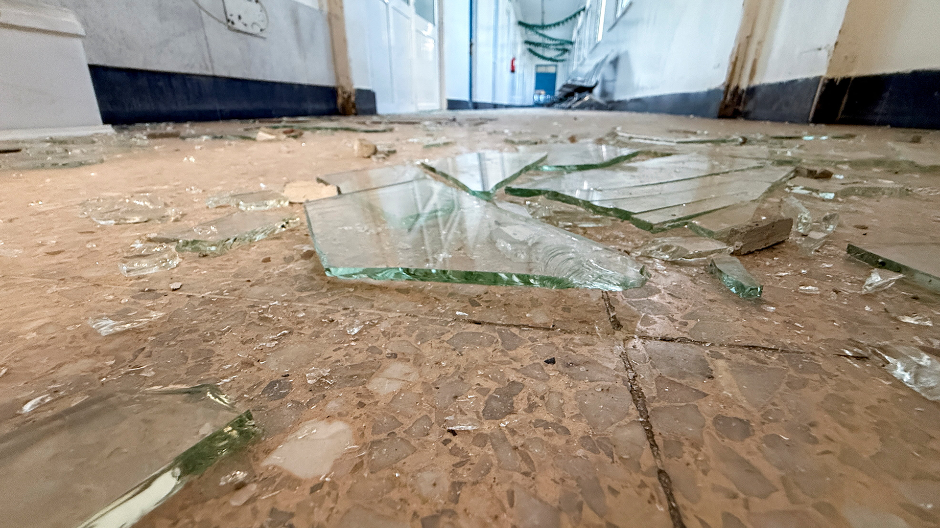 Pieces of shattered glass are scattered across the floor of a hospital following an airstrike on a nearby building in Sanaa, Yemen, October 3, 2026. REUTERS/Adel Al Khader